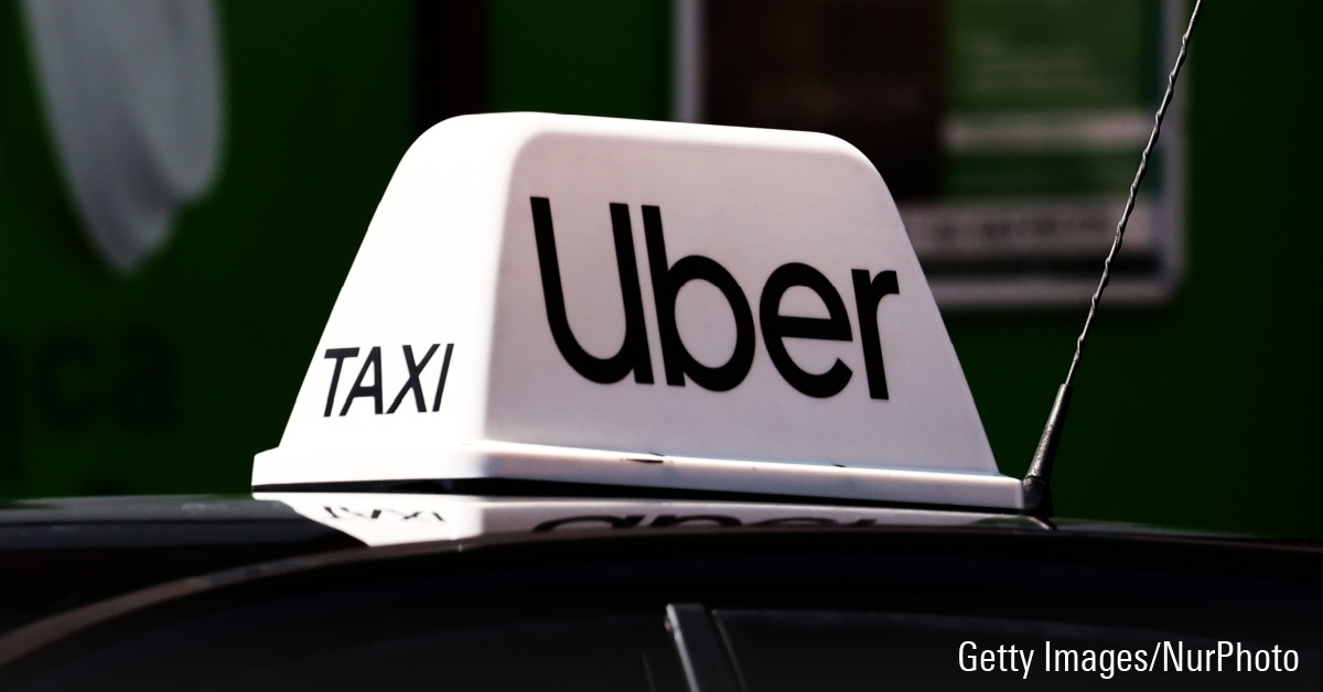 Uber taxi sign on top of a car.