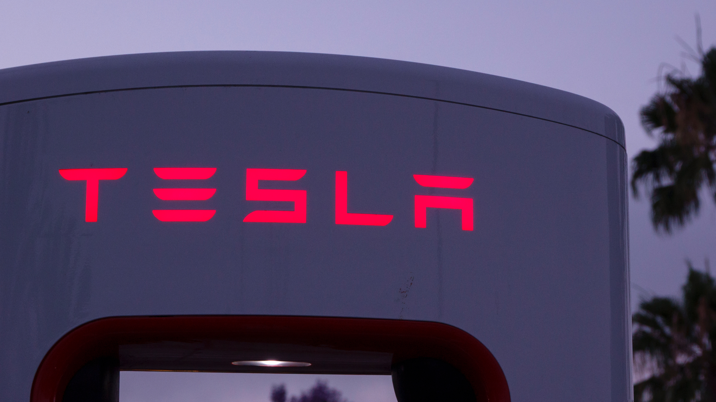 A Tesla logo is displayed on a Tesla Supercharger.