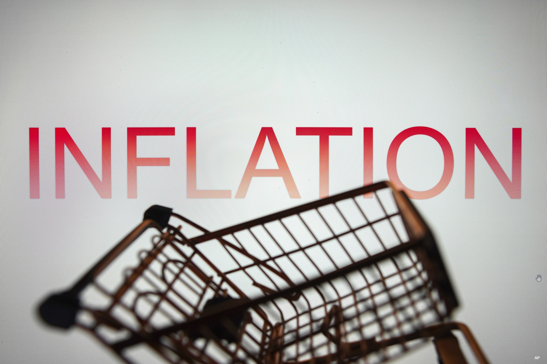 In this photo illustration, the Inflation text seen displayed on a smartphone along with a shopping cart.