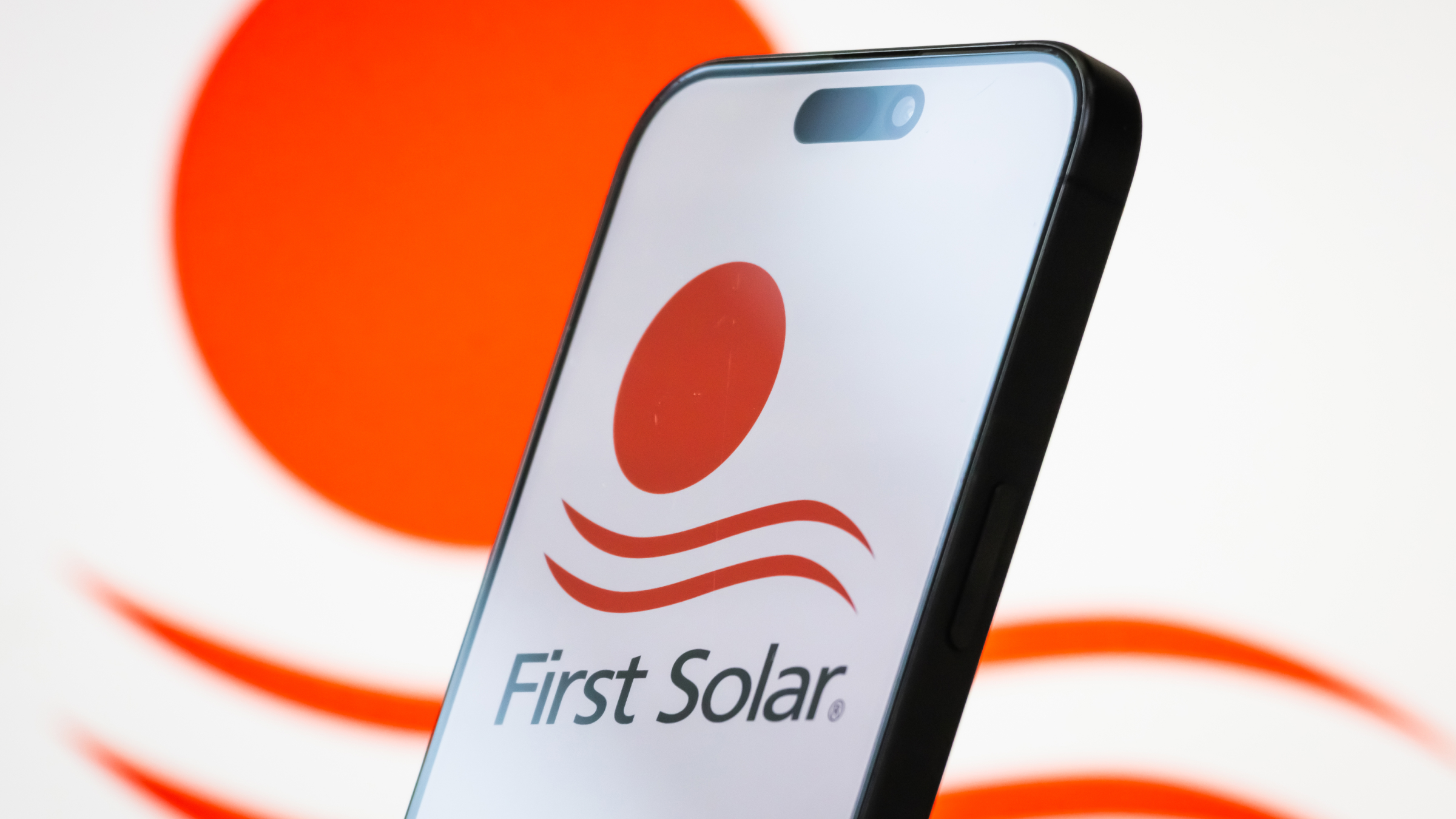 The logo of First Solar, Inc. is displayed on a smartphone screen.