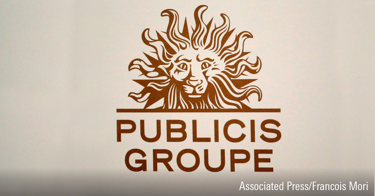 Logo of Publicis Groupe decal in rust orange on an off-white wall