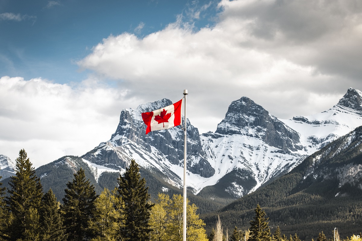 Canadian flag in front of mountains