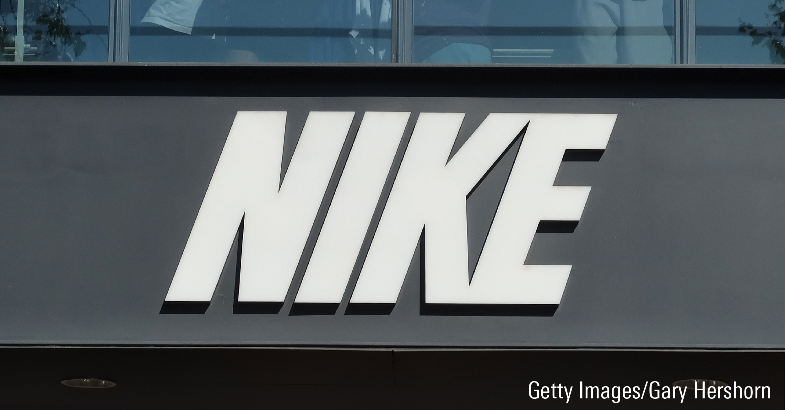 A Nike corporate logo hangs on the front of their store in Los Angeles, California.