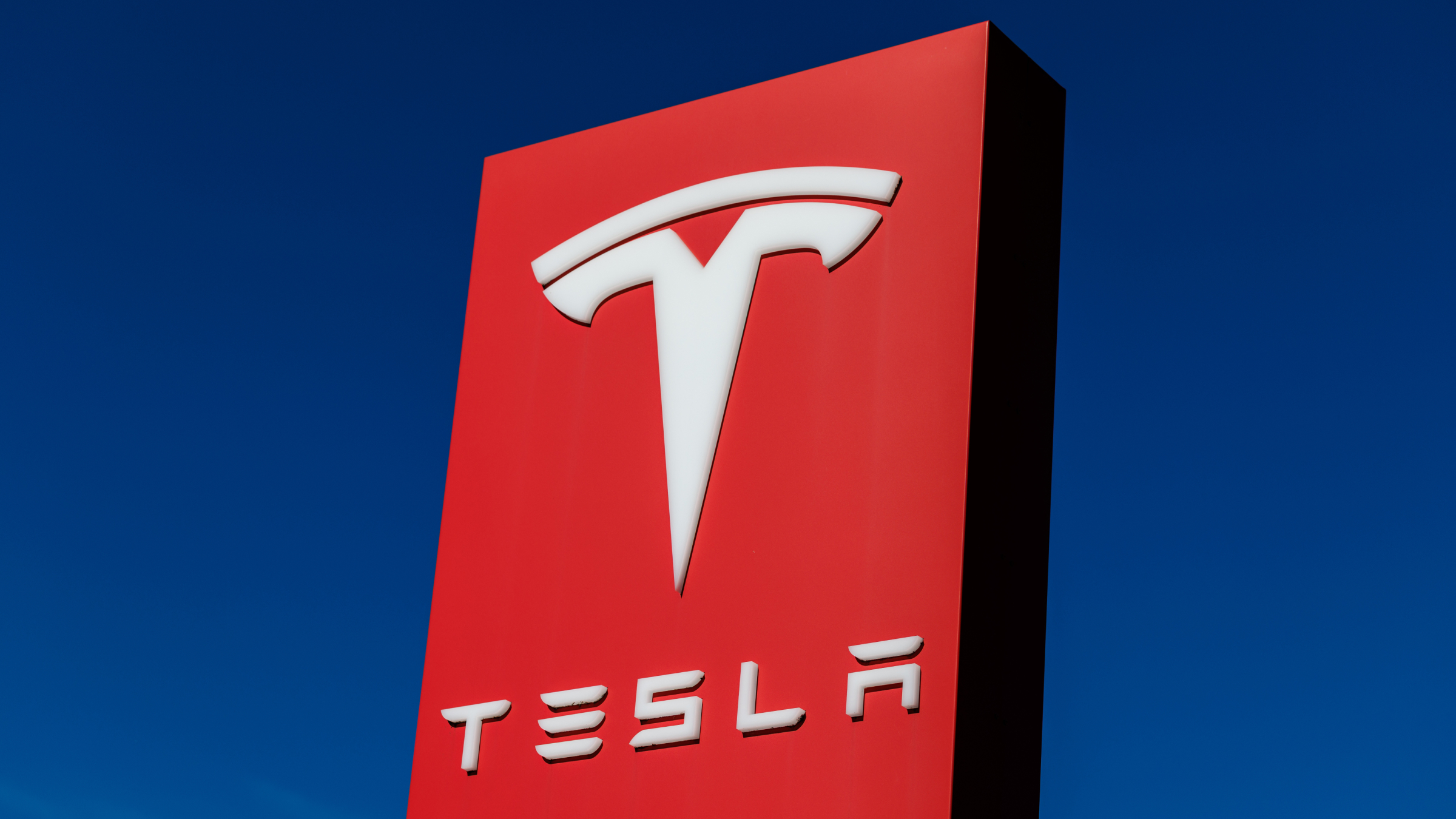 The Tesla logo seen on a sign at a location of the car manufacturer.