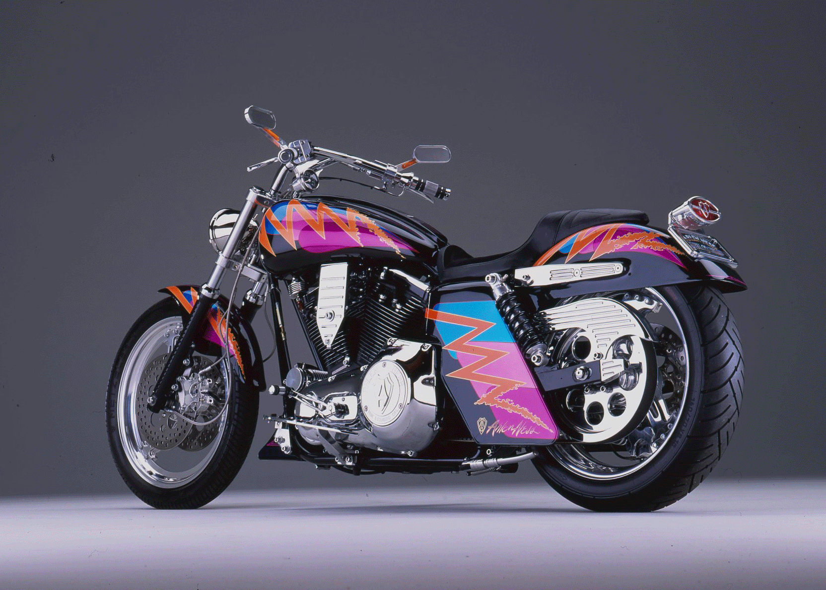 Radical orange zig zags with cyan and pink underneath brighten up this Arlen Ness Dyna Glide.”