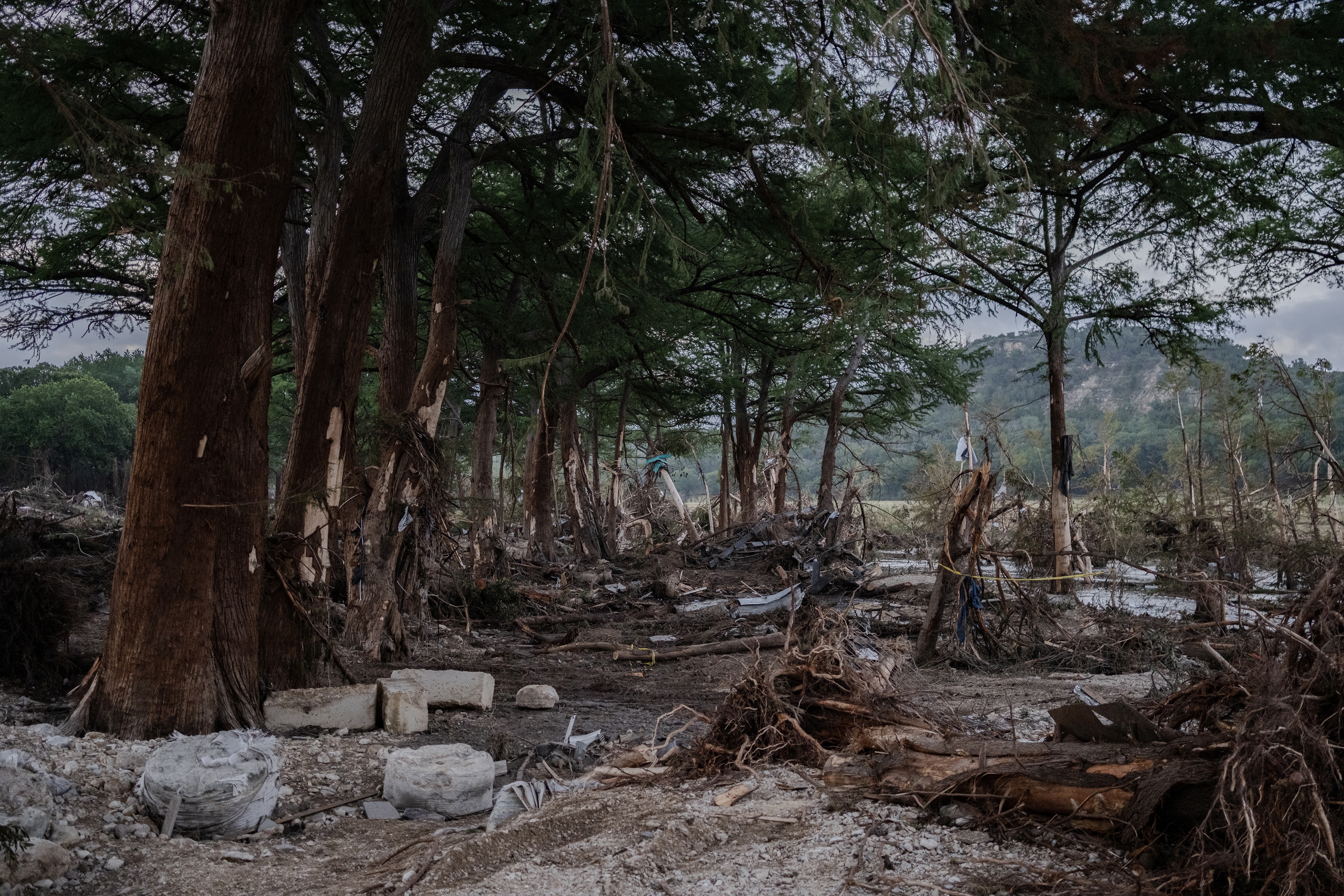 Debris lies along the Guadalupe River.