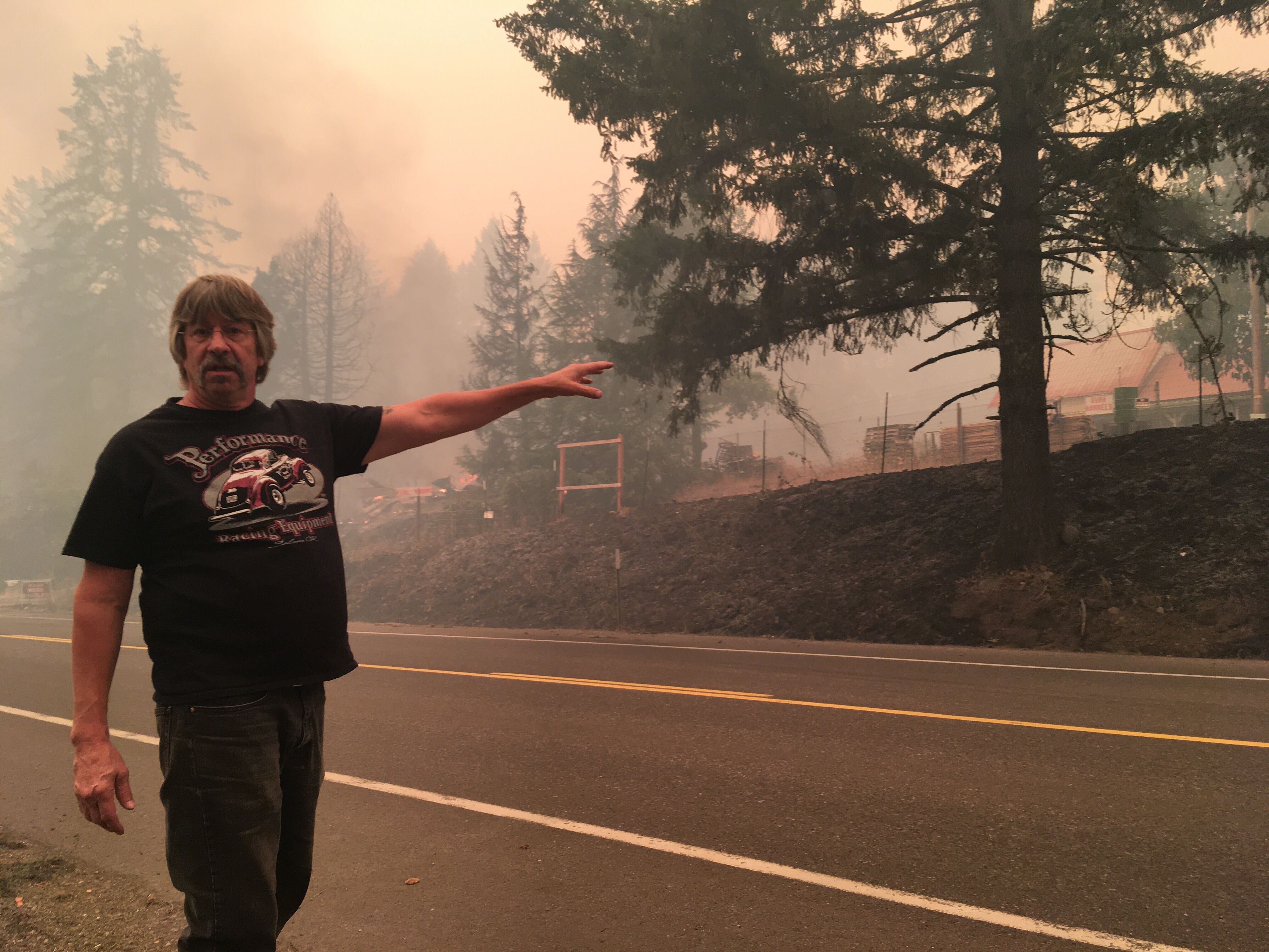 Bob Stifel of Lyons points out the fence he built around what was once his grandparents' house near Mill City. Stifel was driving in the area on Sept. 9, 2020, and discovered the garage was still burning after fire had swept through.