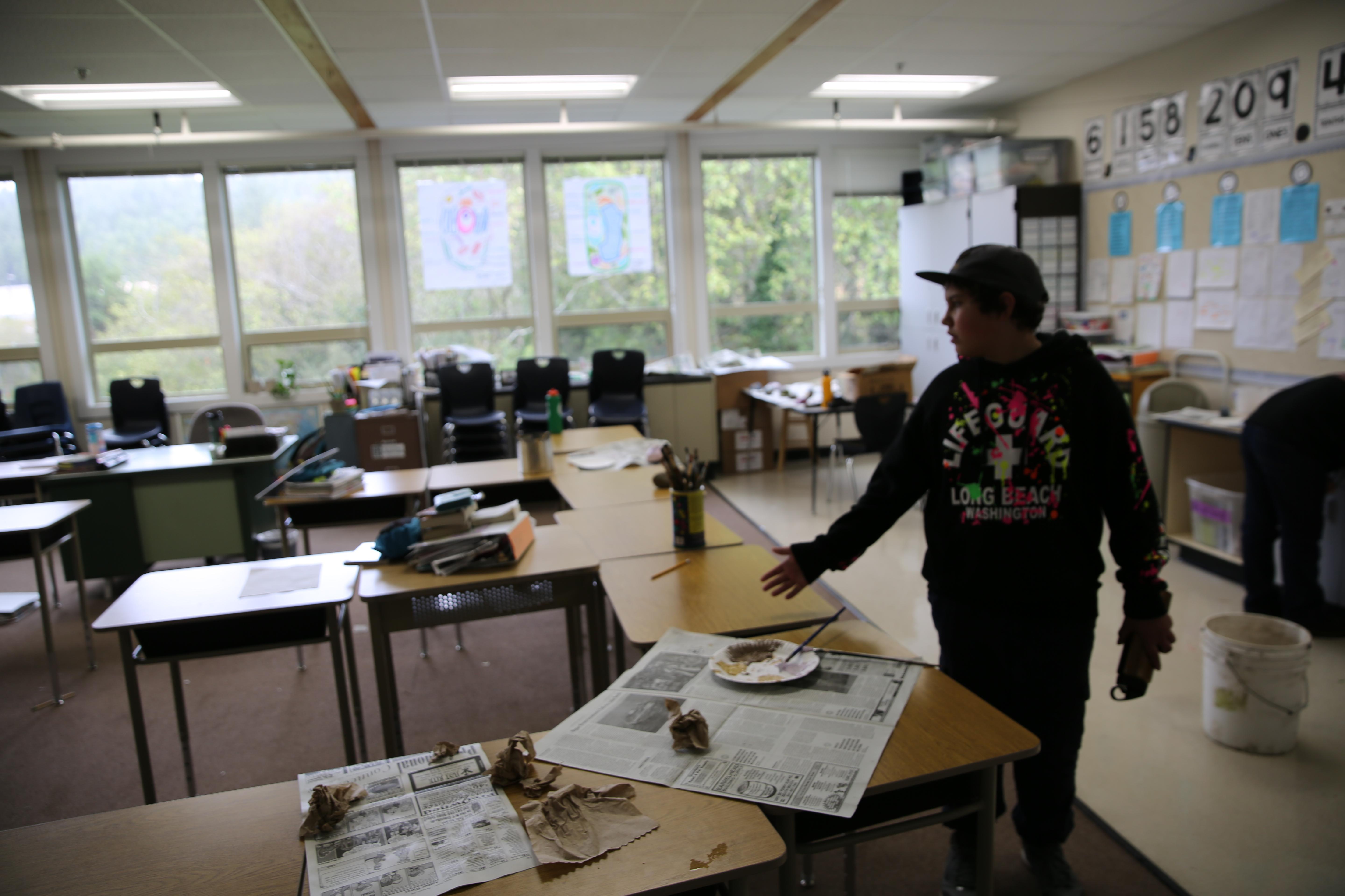 Class Of 2025 student Dale looks over an art project in his sixth grade classroom at Taft Elementary School in Lincoln City, in November 2018.