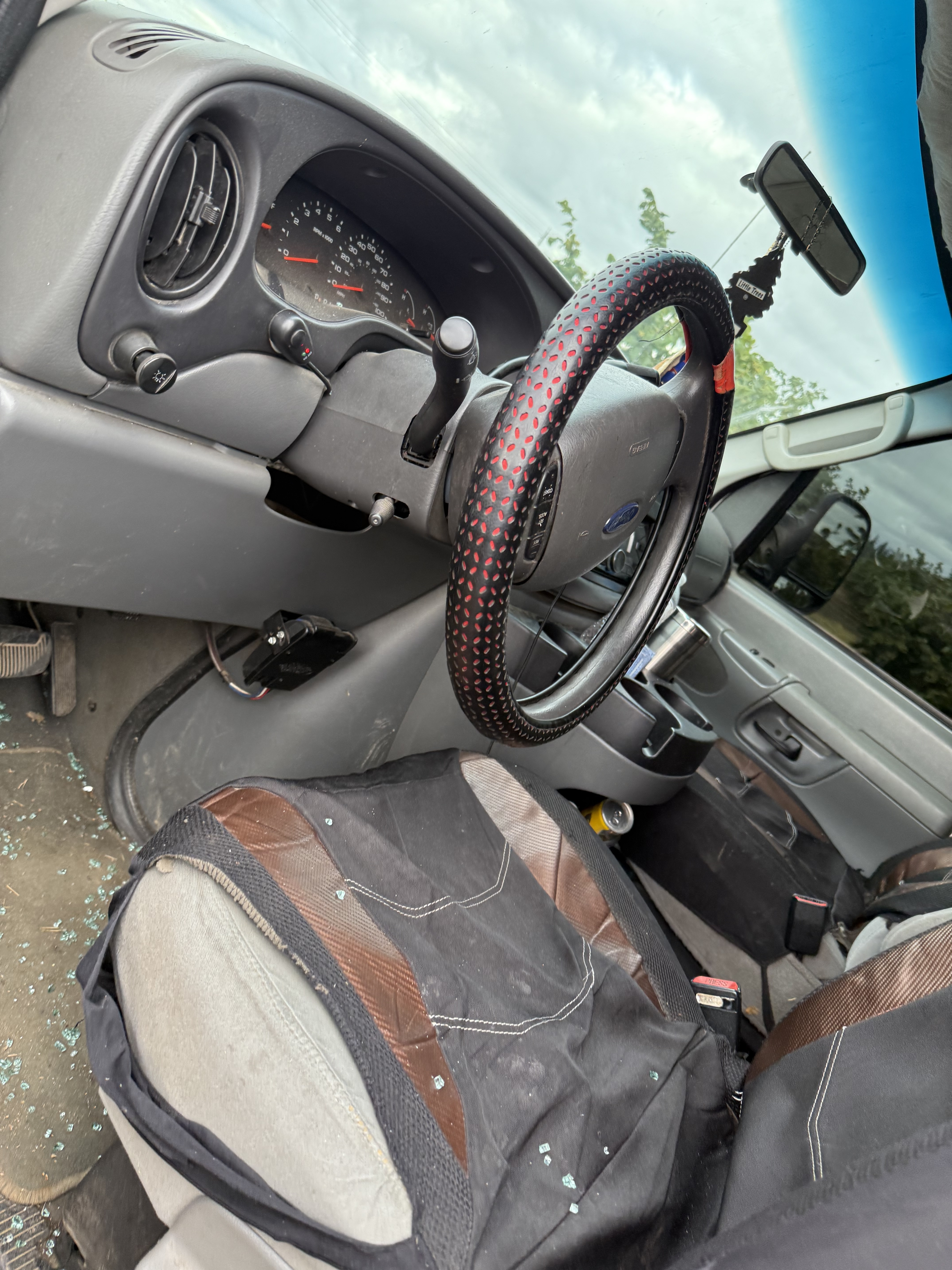 Shards of glass are seen on the driver's seat after ICE agents broke the van window and arrested four farmworkers on Aug. 7, 2025.