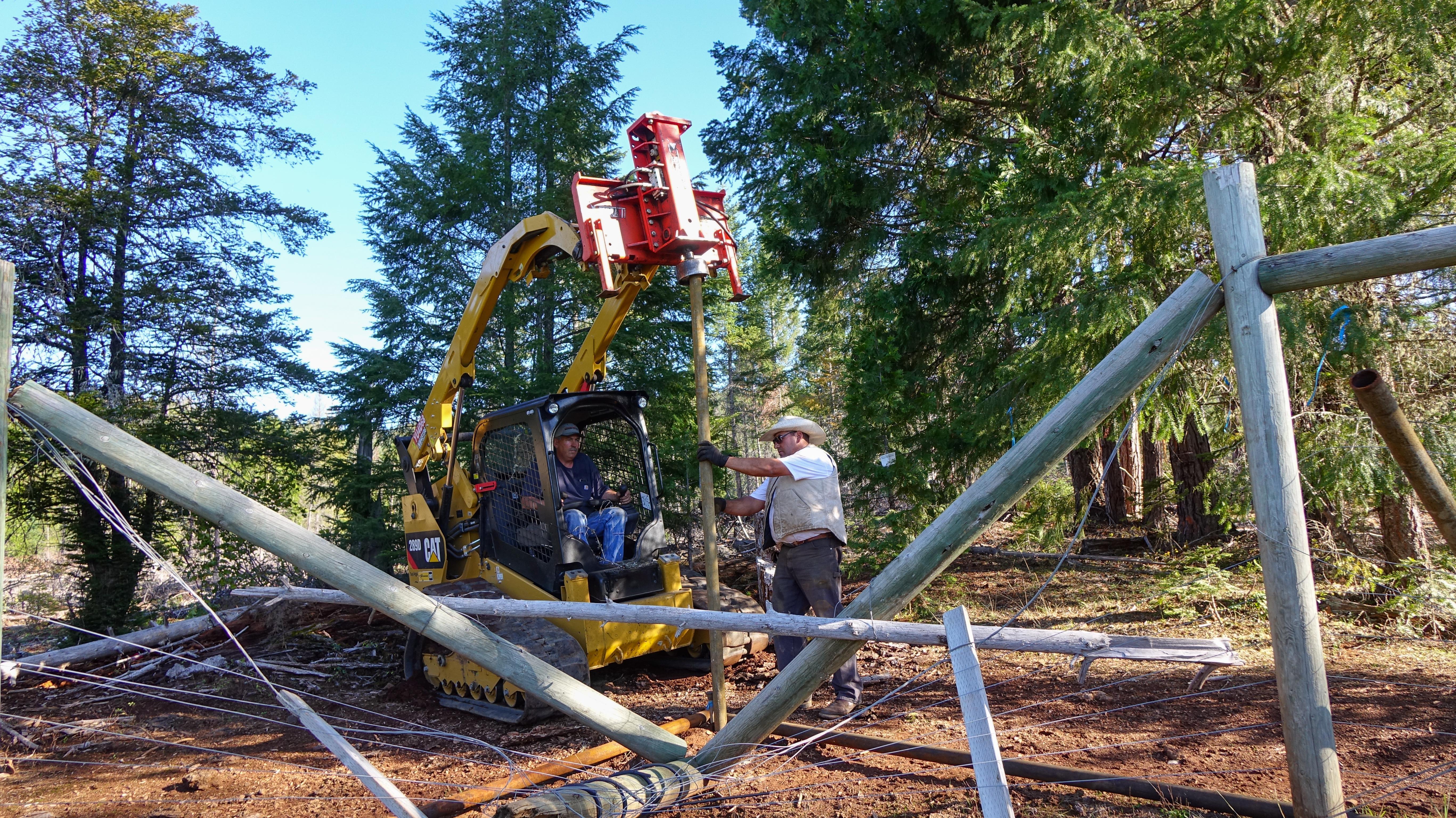 John Carpenter and Pedro Ibarra install a fence designed to keep wolves off the Mill-Mar Ranch in Southern Oregon.