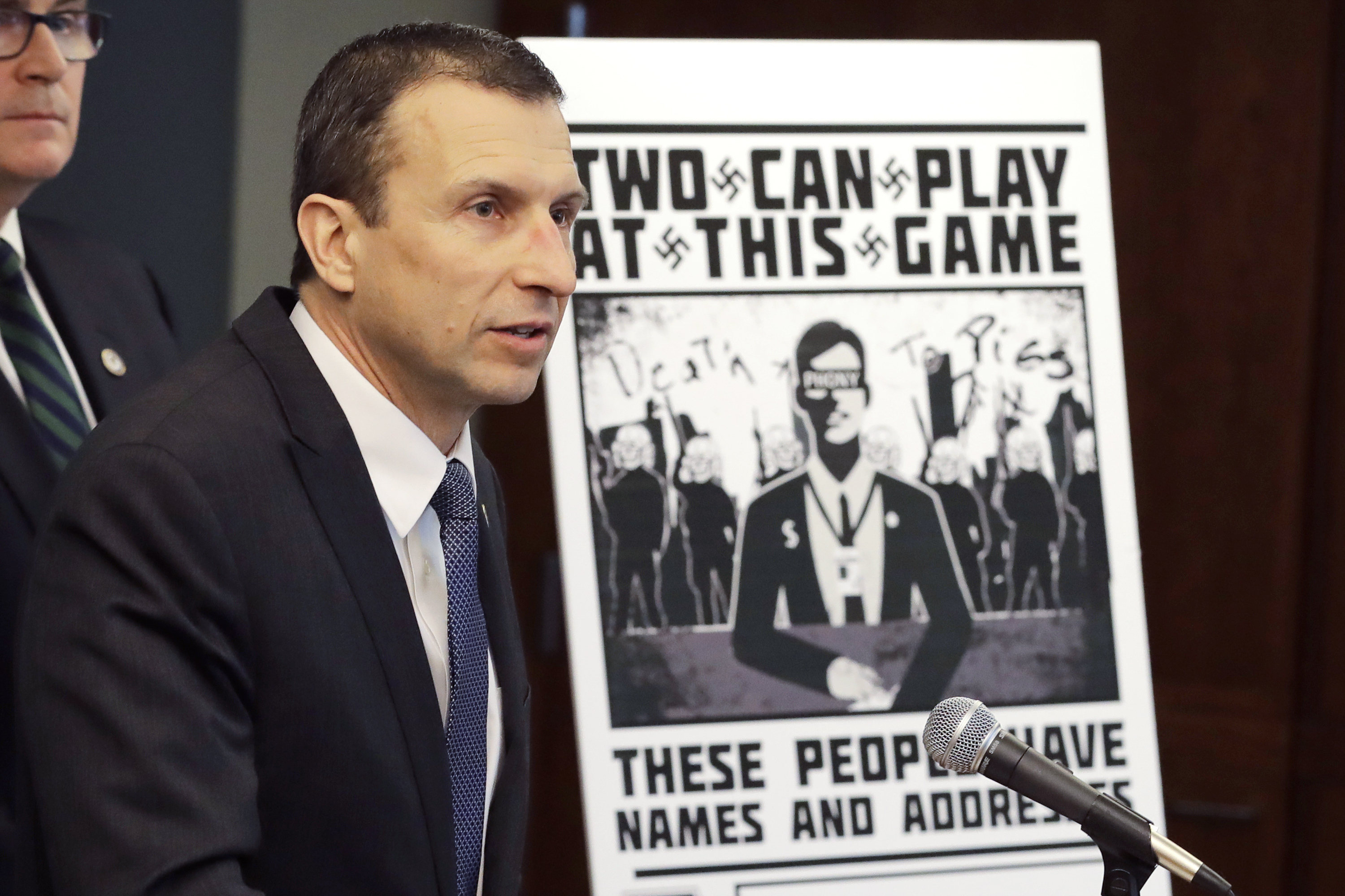 FILE - In this Feb. 26, 2020, file photo, Raymond Duda, special agent in charge in Seattle, speaks as he stands next to a poster that was mailed earlier in the year to the home of Chris Ingalls, an investigative reporter with KING-TV in Seattle, during a news conference in Seattle. A federal jury in Seattle on Wednesday, Sept. 29, 2021, convicted Kaleb Cole, a leader of a neo-Nazi campaign to threaten journalists and Jewish activists in three states. Cole and three others were charged last year with having sent Swastika-laden posters to journalists and people affiliated with the Anti-Defamation League in Washington, Florida and Arizona.