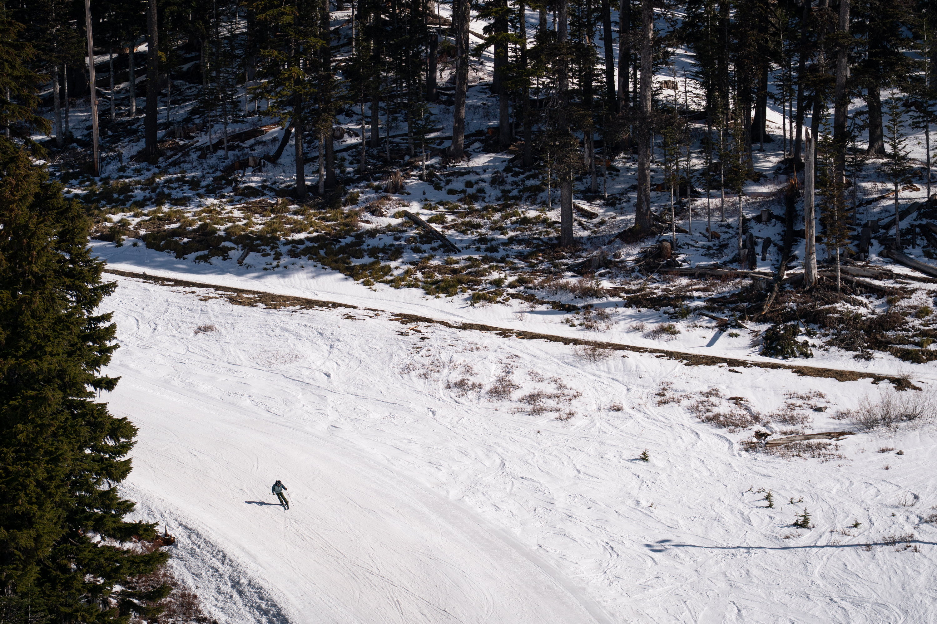 A skier goes down a run as snow gets patchy just beyond the groomed area at Mt. Hood Meadows on April 4, 2026.