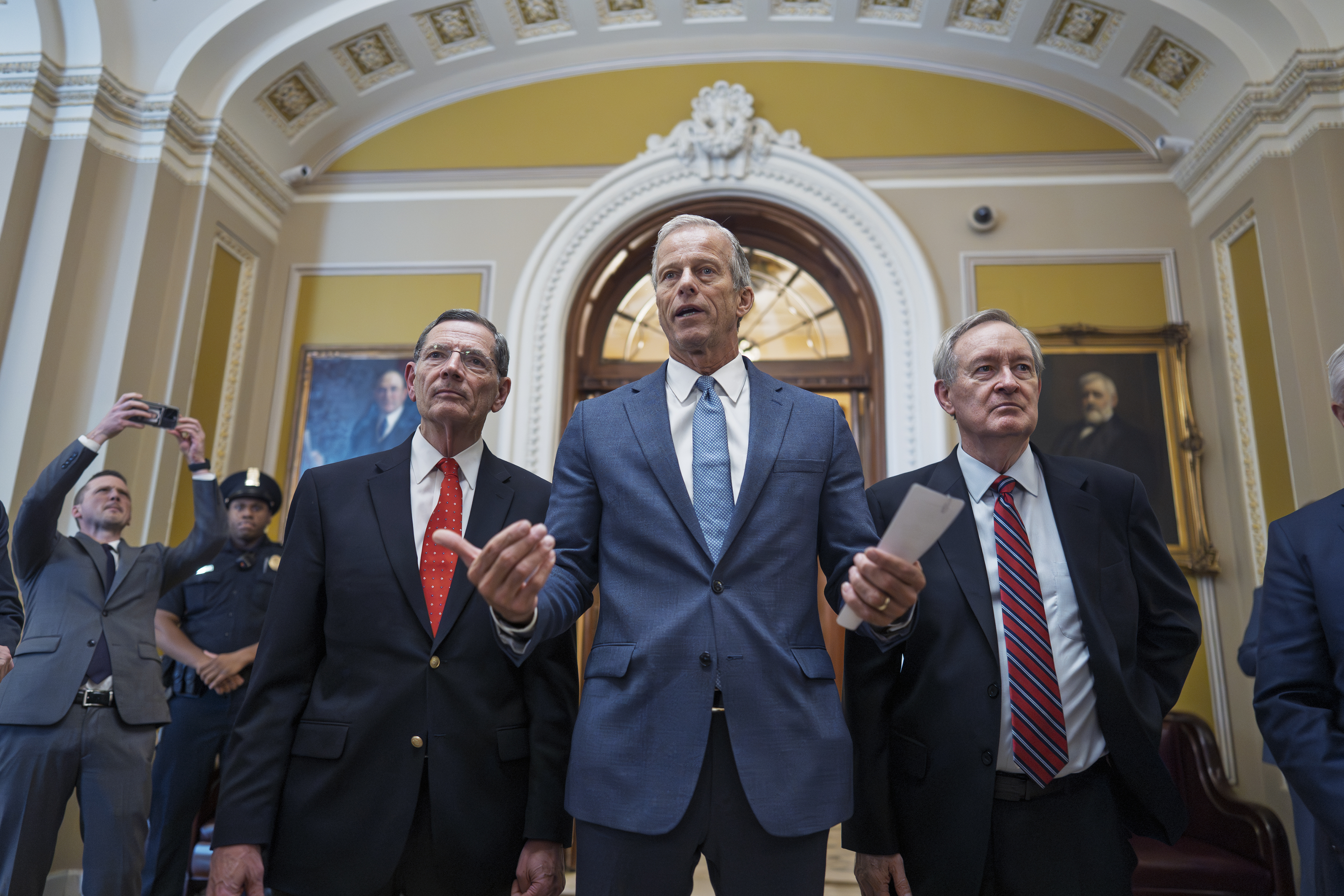 Senate Majority Leader John Thune, R-S.D., is flanked by Sen. John Barrasso, R-Wyo., the GOP whip, left, and Finance Committee Chairman Mike Crapo, R-Idaho, speaks to reporters just after passage of the budget reconciliation package of President Donald Trump's signature bill of big tax breaks and spending cuts, at the Capitol in Washington, Tuesday, July 1, 2025. The bill now moves back to the House for final consideration.