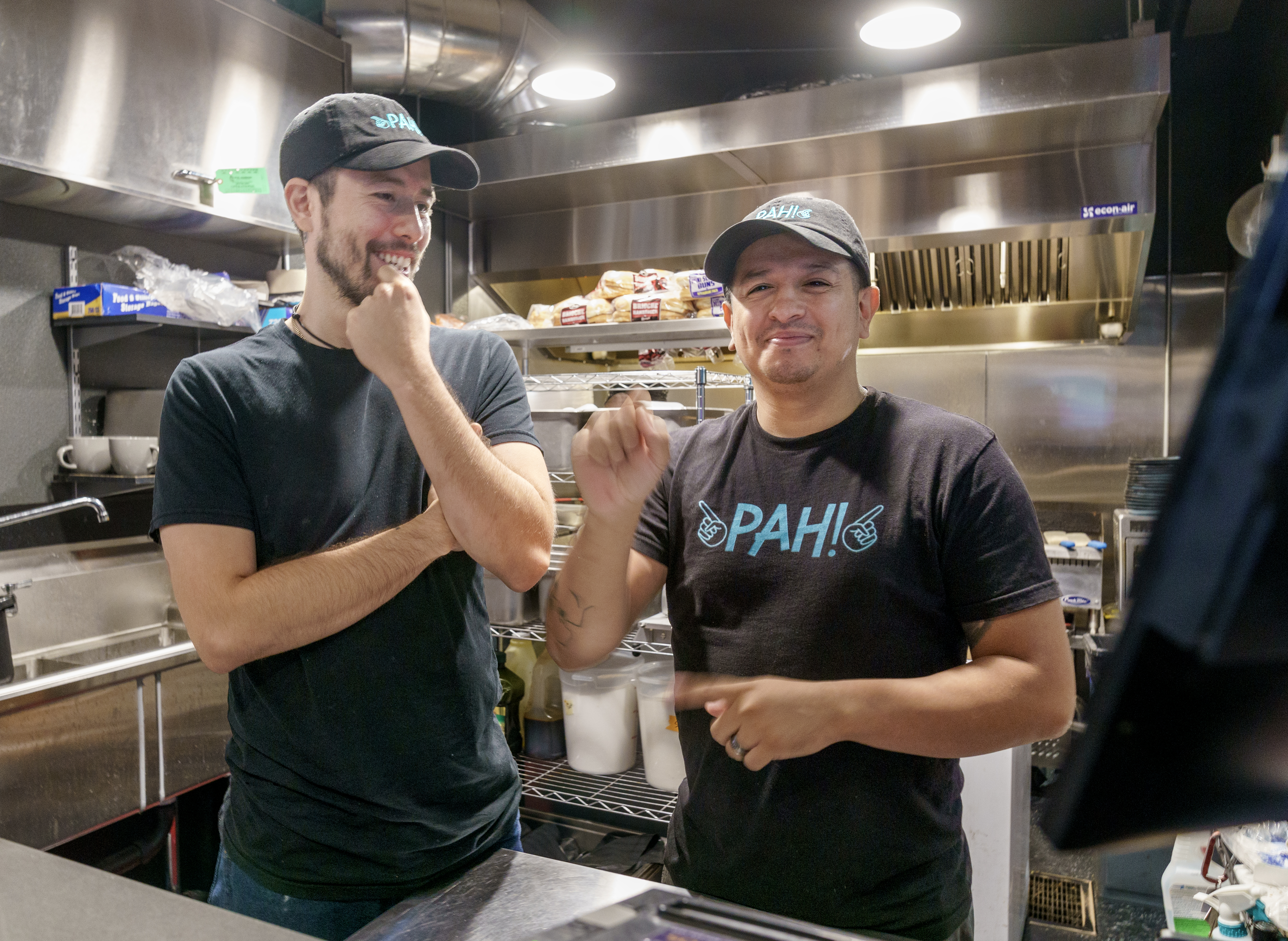 Victor Covarrubias, left, talks with his husband Lillouie Barrios, at their restaurant, Pah!, in Southeast Portland, Sept. 28, 2022. Barrios, who is deaf, had a vision to open a restaurant where he could serve the Deaf community as well as share Deaf culture with hearing people. The business name, Pah!, is American Sign Language slang for “finally” or “success”.