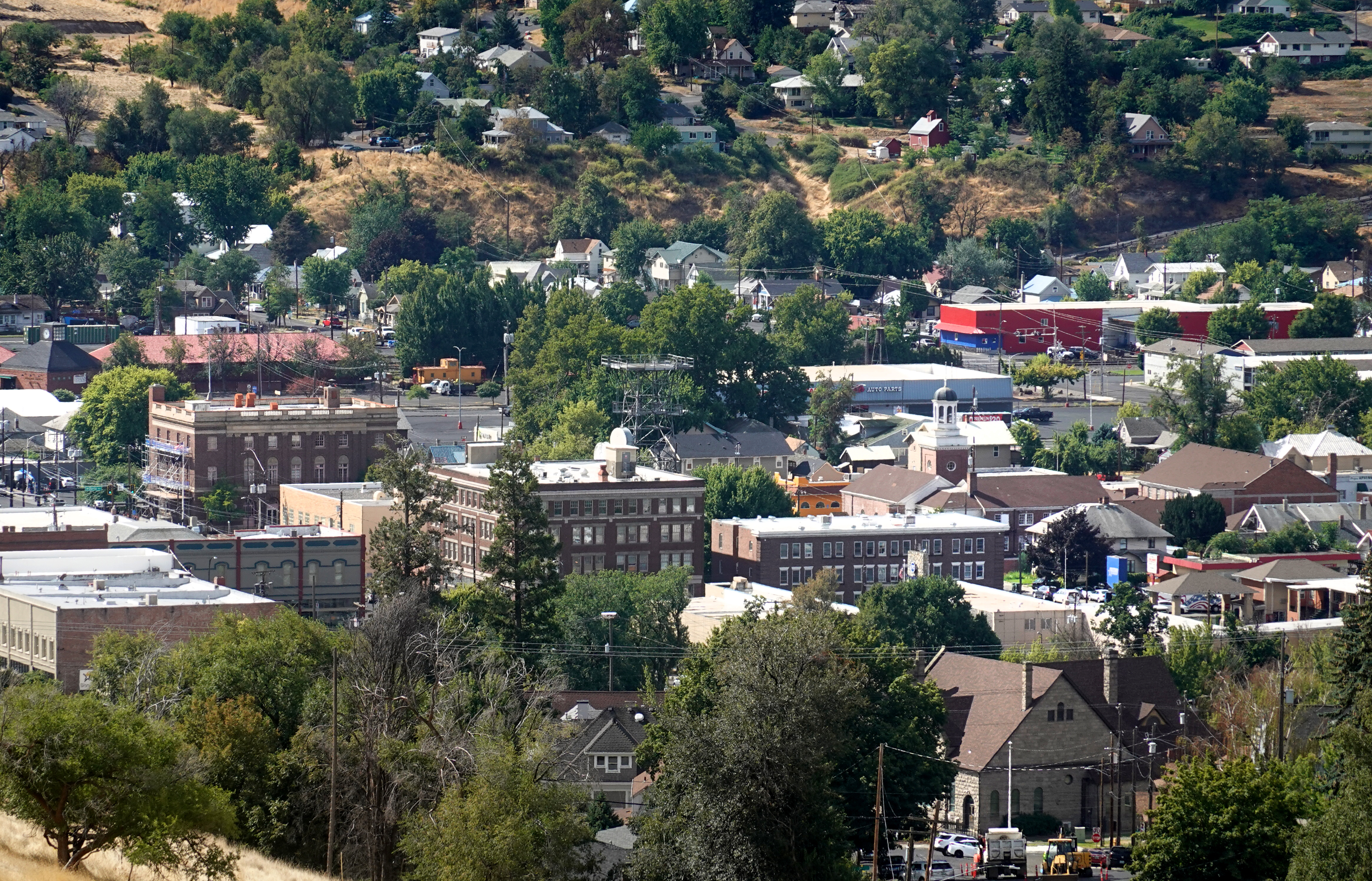 Several historic red brick buildings emerge from the downtown area, which is viewed from a distance.