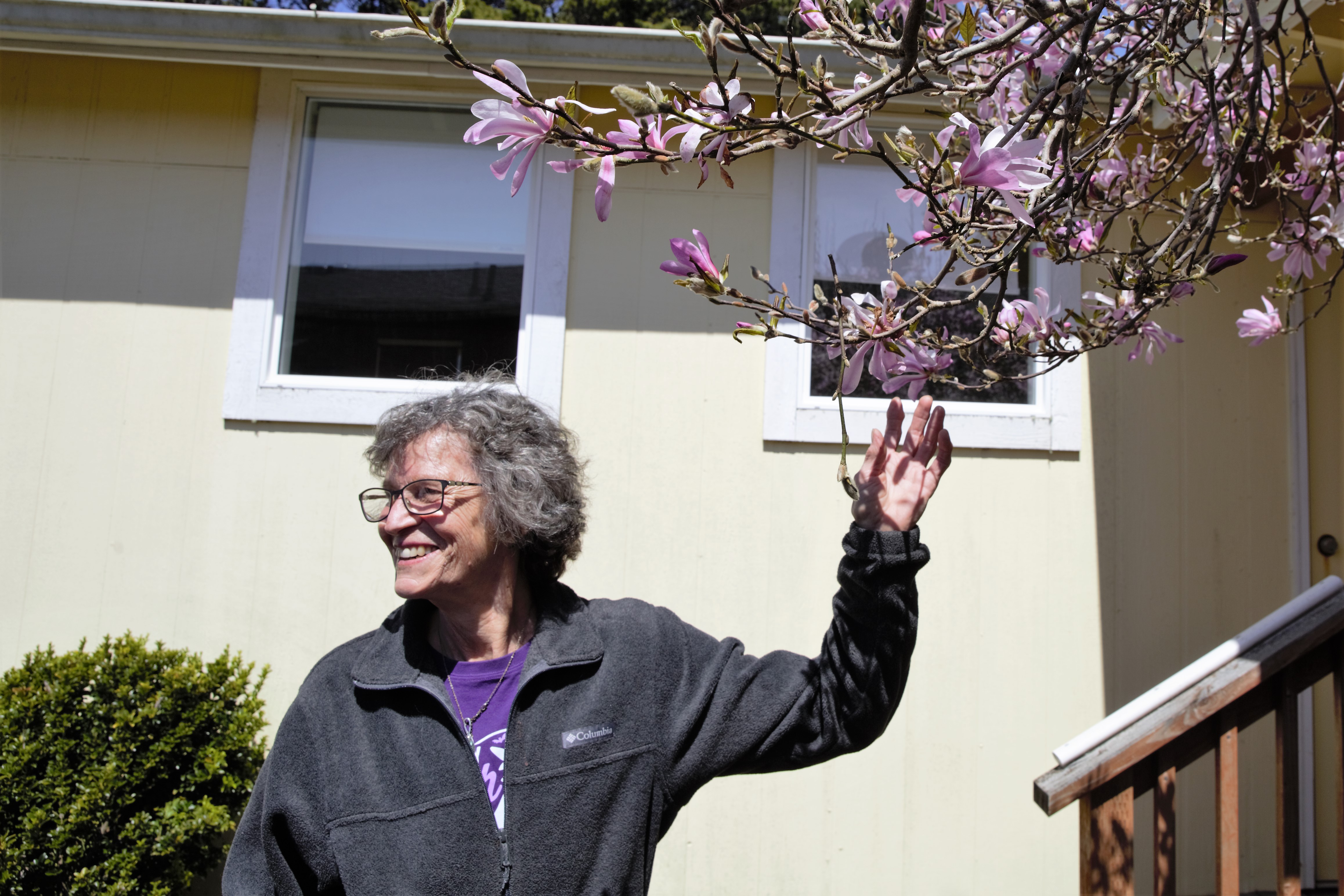 Gardner Jean Girard admires the blossoms outside Seal Rock Garden Club on April 26, 2023.