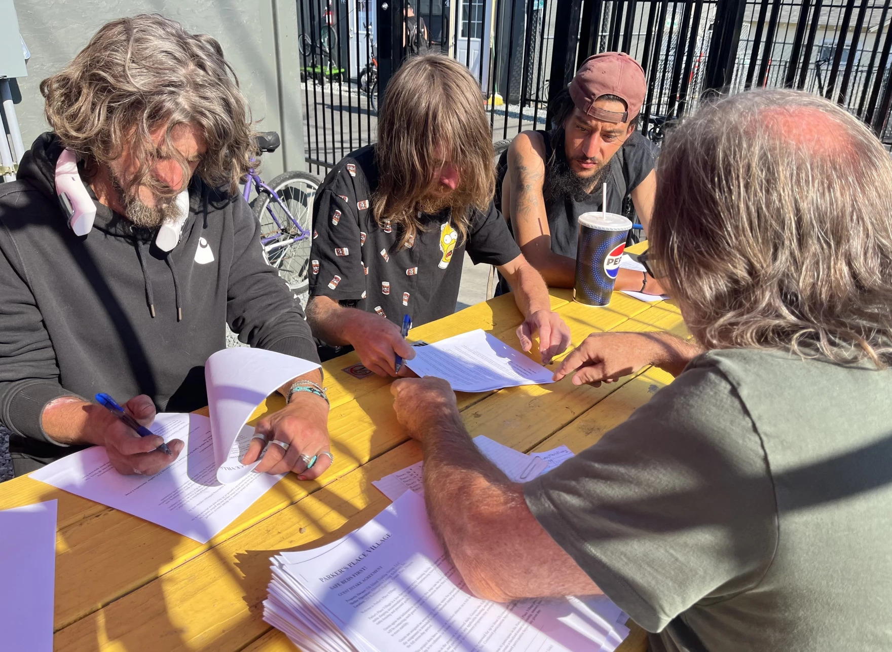 Elk Island Operations Manager Bernie Woodard, right, helps new Parker's Place Village residents fill out paperwork. Shown Aug. 4, 2026.