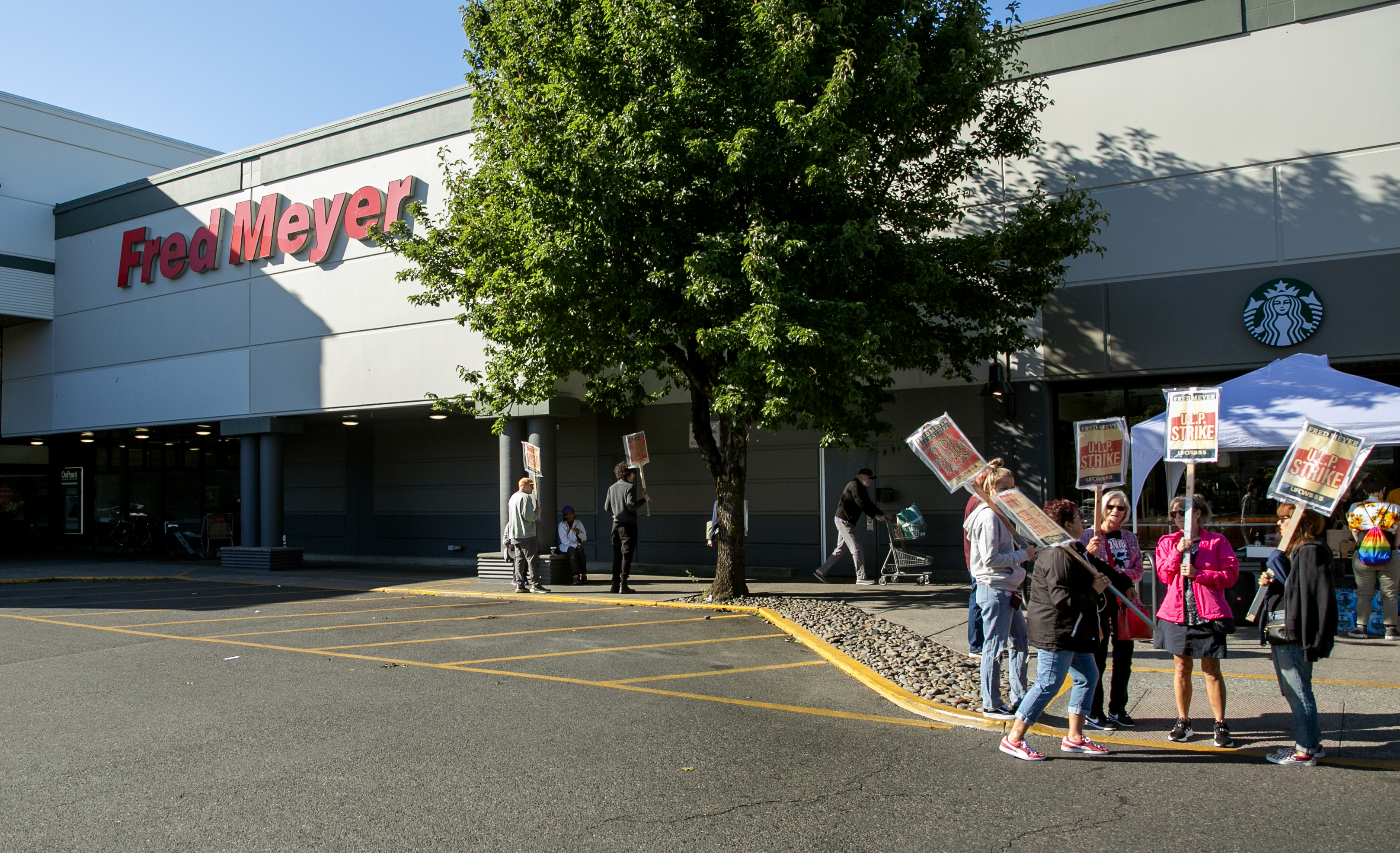 Workers gather on the picket line outside of the Hollywood Fred Meyer store in Portland, Ore., Aug. 28, 2024. Employees at 28 Fred Meyer locations across Portland went on strike at 6 a.m. Wednesday morning in protest of unfair labor practices.
