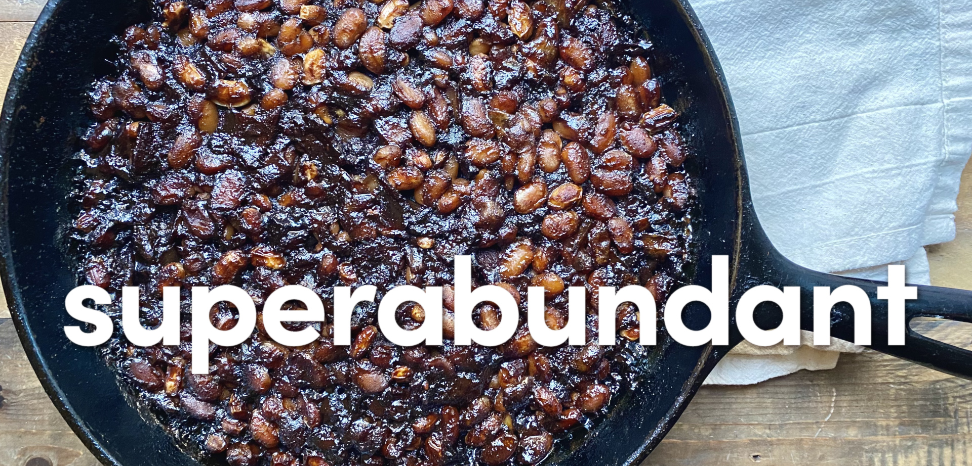 Blackberry baked beans in a cast iron pan.