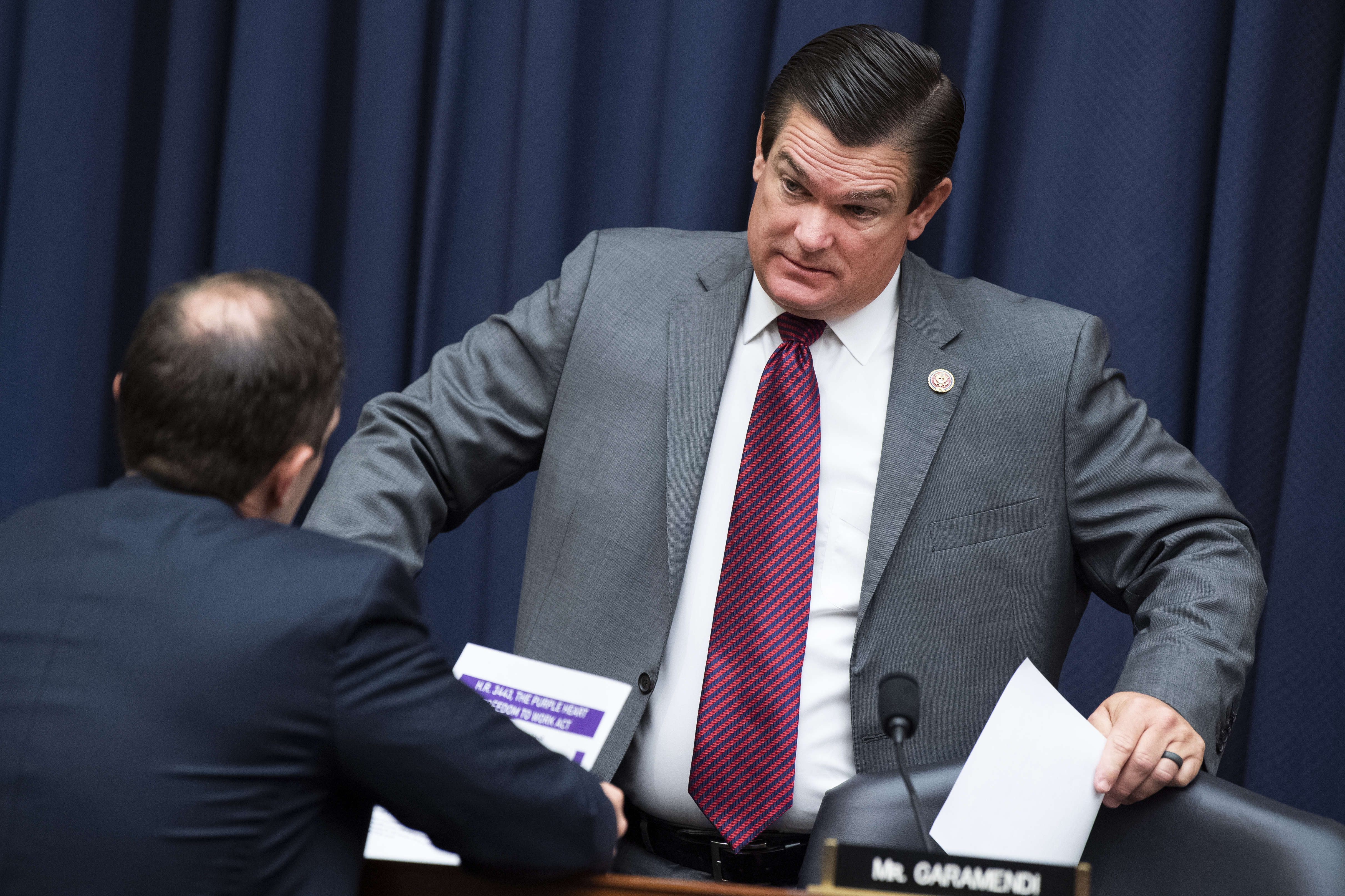 Rep. Austin Scott, R-Ga., right, and Rep. Jason Crow, D-Colo., talk during a break in the House Armed Services Committee hearing in 2021. On Friday Scott announced his candidacy for House speaker.