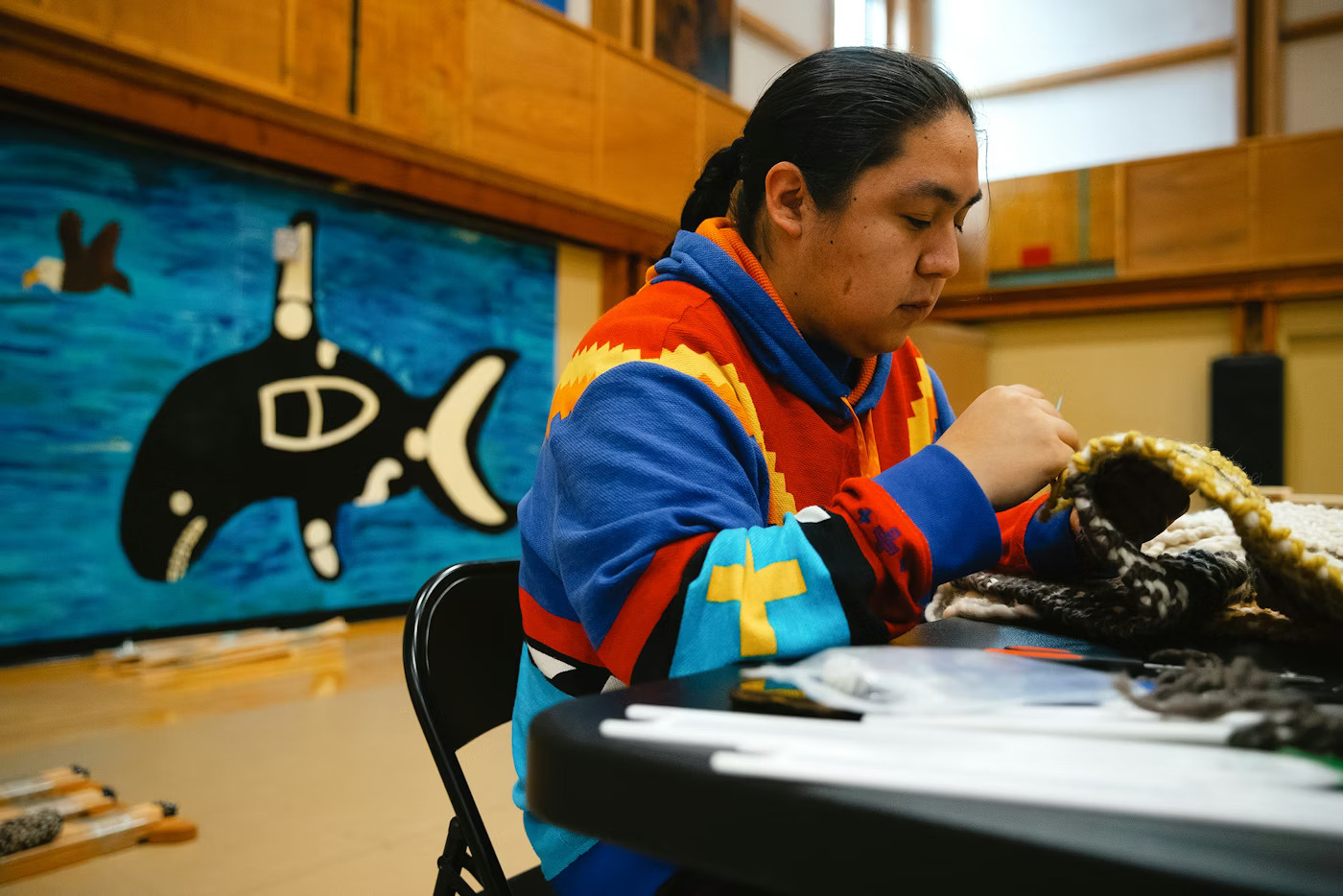 Syrille Jones, 24, weaves a speaker sash during a weaving class with instructor Susan Pavel of the Coast Salish Wool Weaving Center, on Saturday, March 7, 2026, at the Don Hatch Youth Center in Tulalip.