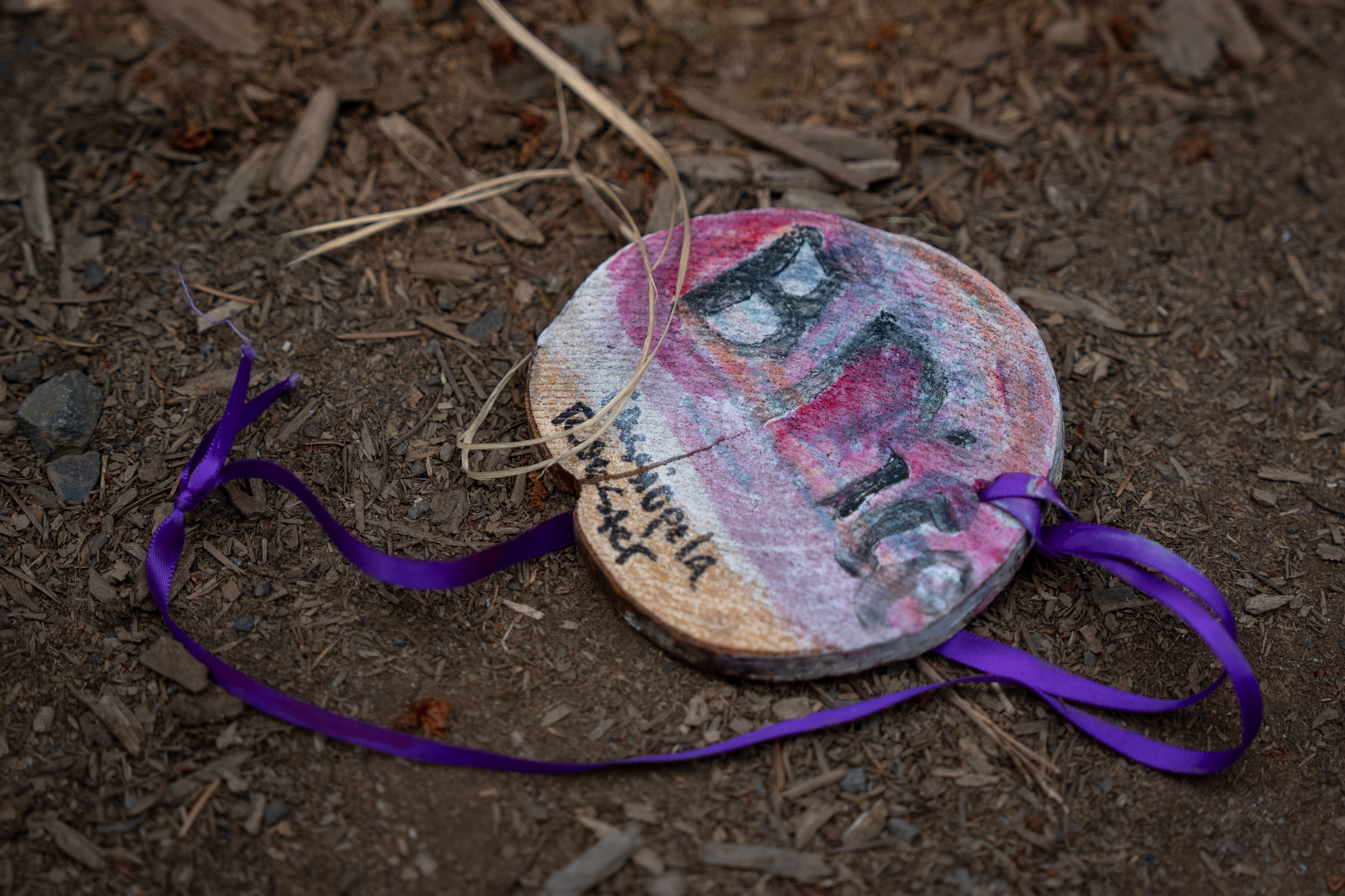 A camper’s name tag lies unattended in the dirt.