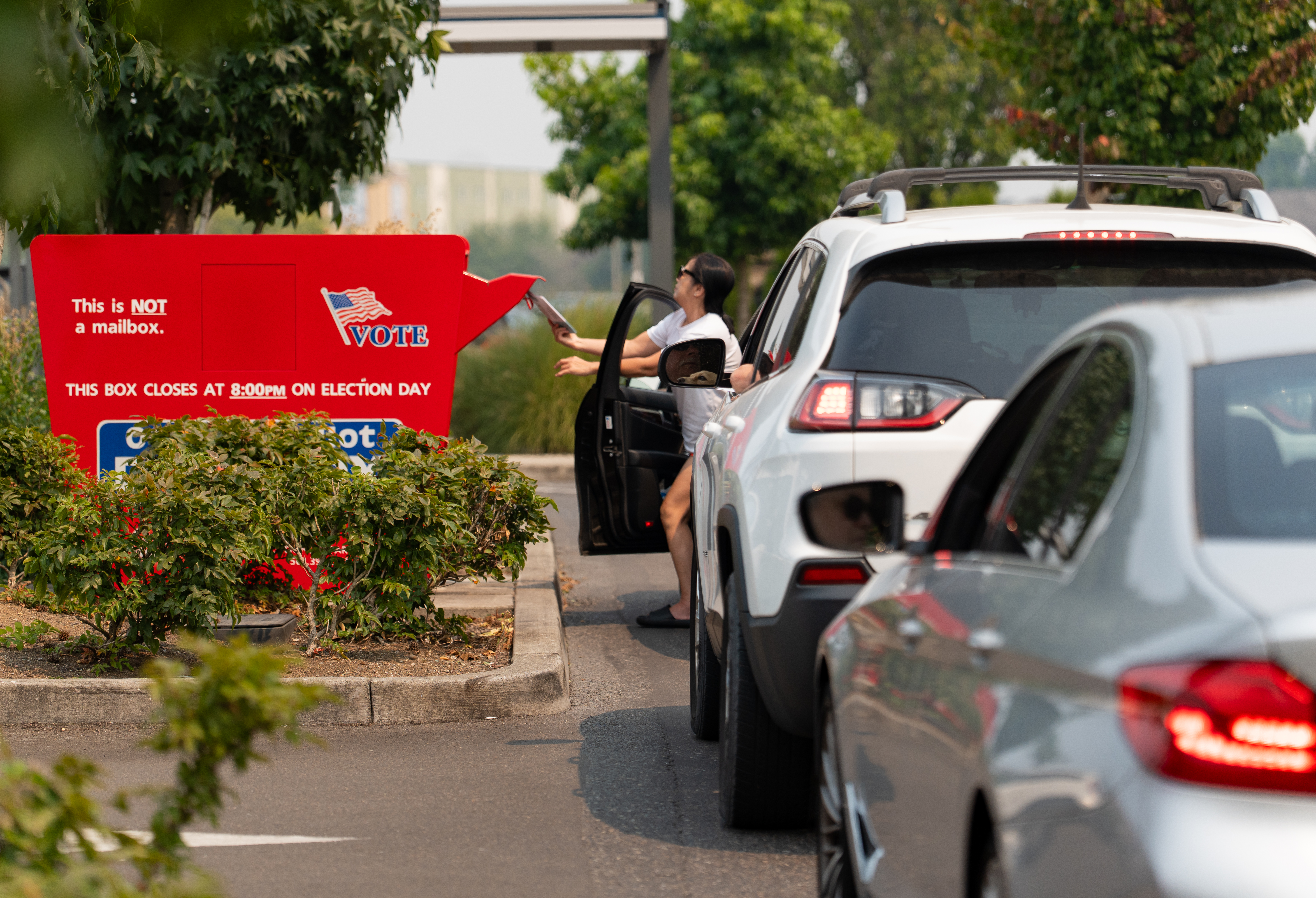 Voters drop off ballots in a ballot box at Vancouver Mall in Vancouver, Wash., on Aug. 4, 2026.
