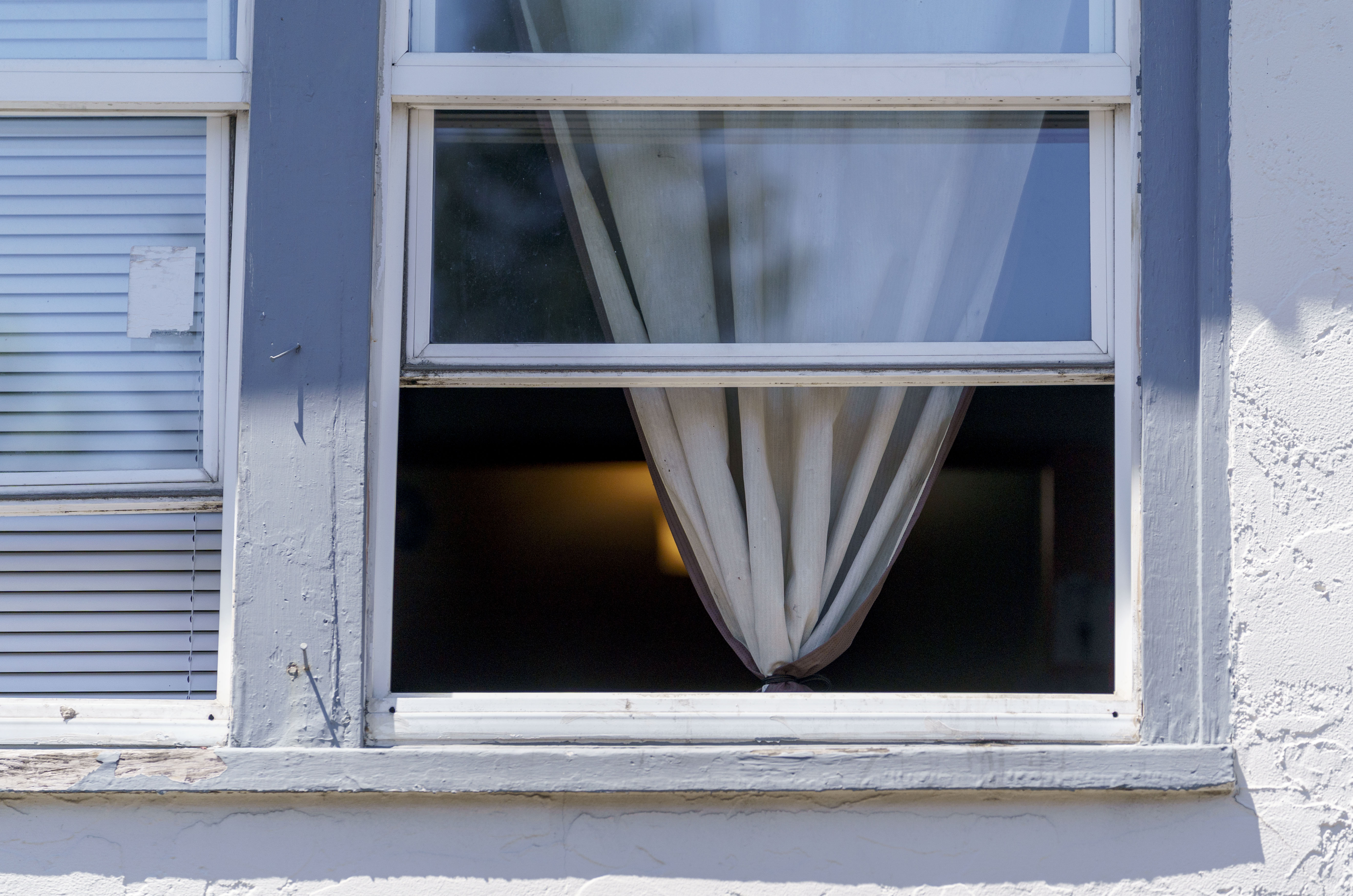 An apartment dweller keeps the windows open, seeking relief from the heat, in Portland, June 27, 2022.