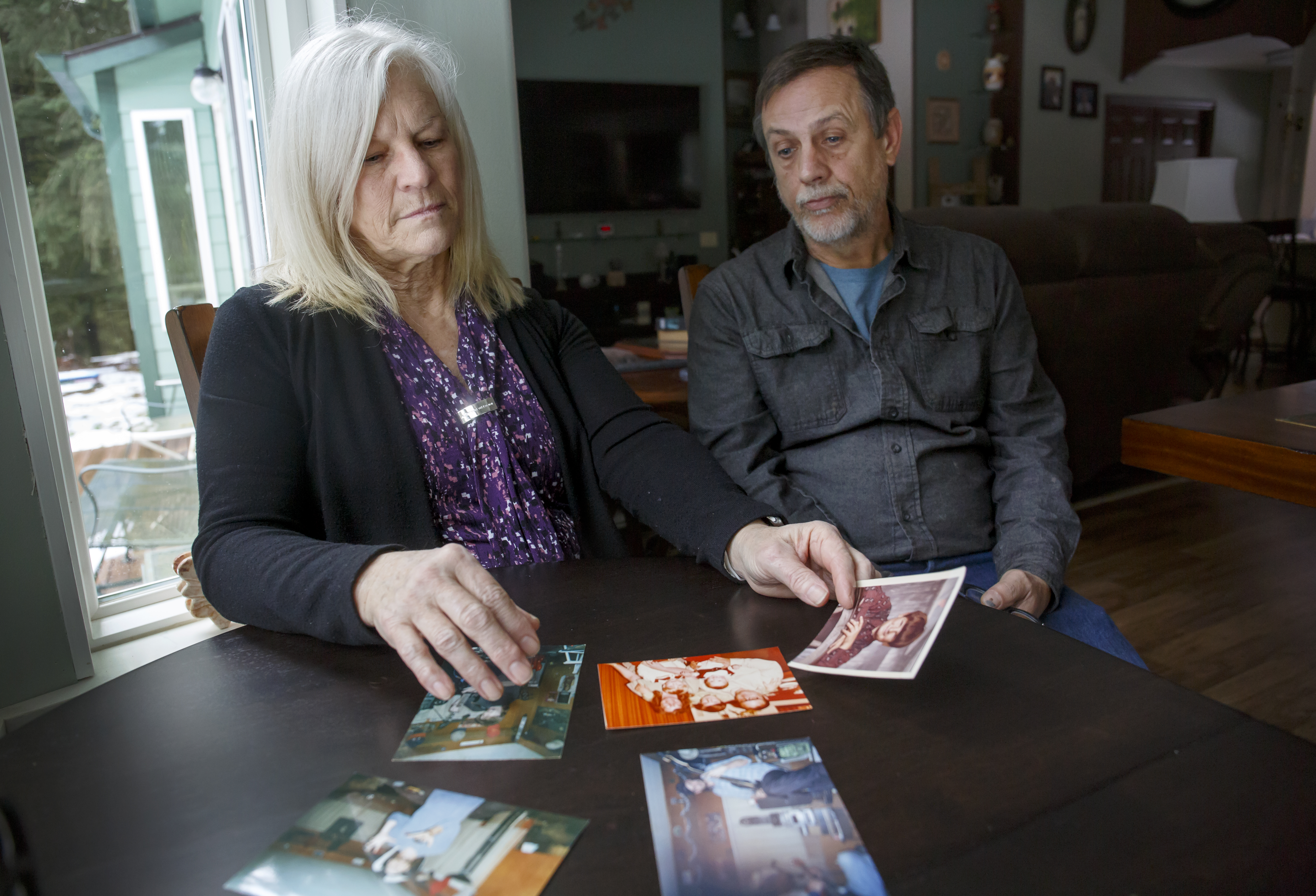 Treva Smith, left, and her husband Chris look over photos of their nephew William Abbe at their Manning-area home, Jan. 28, 2021. Abbe, who lived with mental illness, was the first person killed by Vancouver police in 2020.