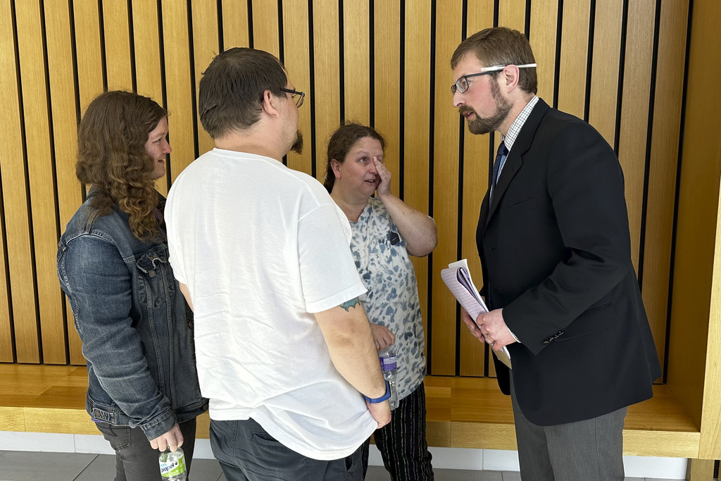 Plaintiff Rachelle McMaster wipes tears from her eyes as one of her attorneys greets her after a jury in Portland, Ore., on Monday, June 12, 2023, awarded her $4.5 million in non-economic damages and about $150,000 in economic damages after finding the electric utility PacifiCorp liable for wildfires in 2020.