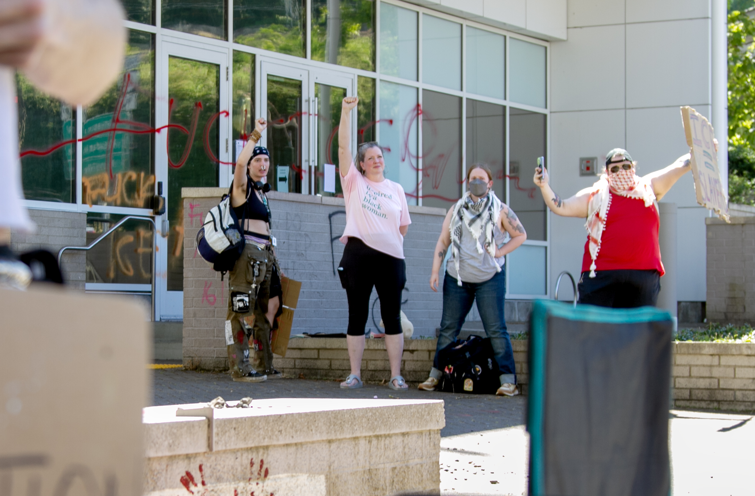 Some of the roughly 20 people protesting U.S. Immigration and Customs Enforcement in Portland stand outside their main office on Monday. Recent clashes in Los Angeles over immigration have raised concerns about mounting tensions in Portland.