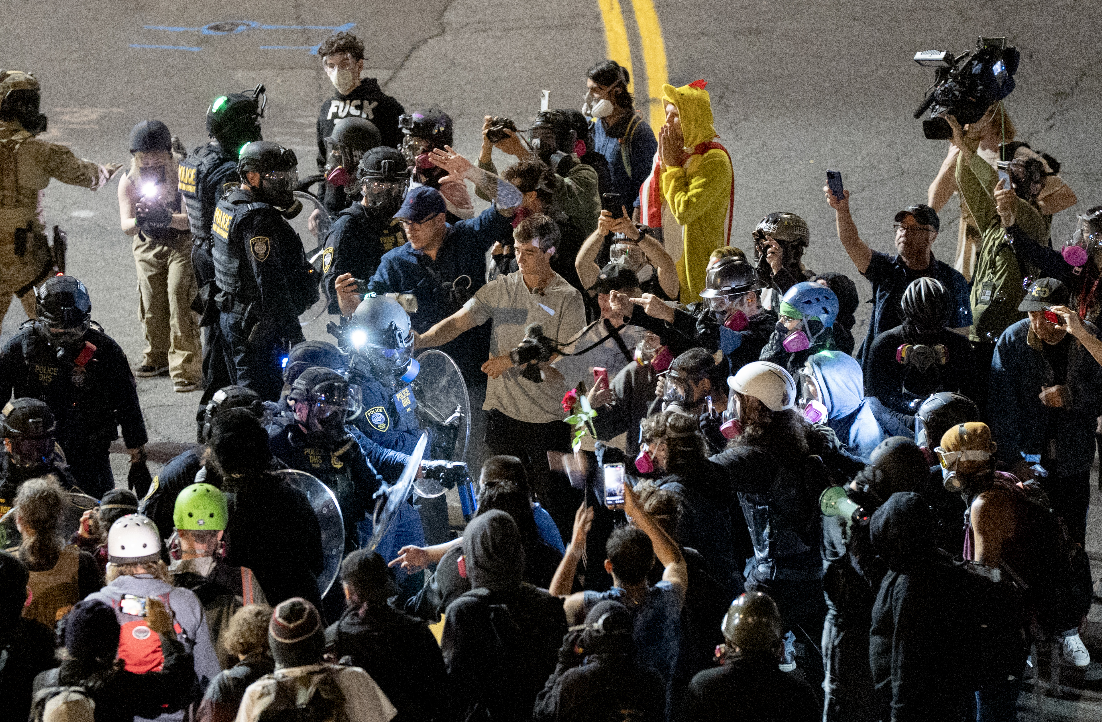 Masked-up federal agents confront the protesters outside the U.S. Immigration and Customs Enforcement facility in Portland, Ore., on Sept. 28, 2025.
