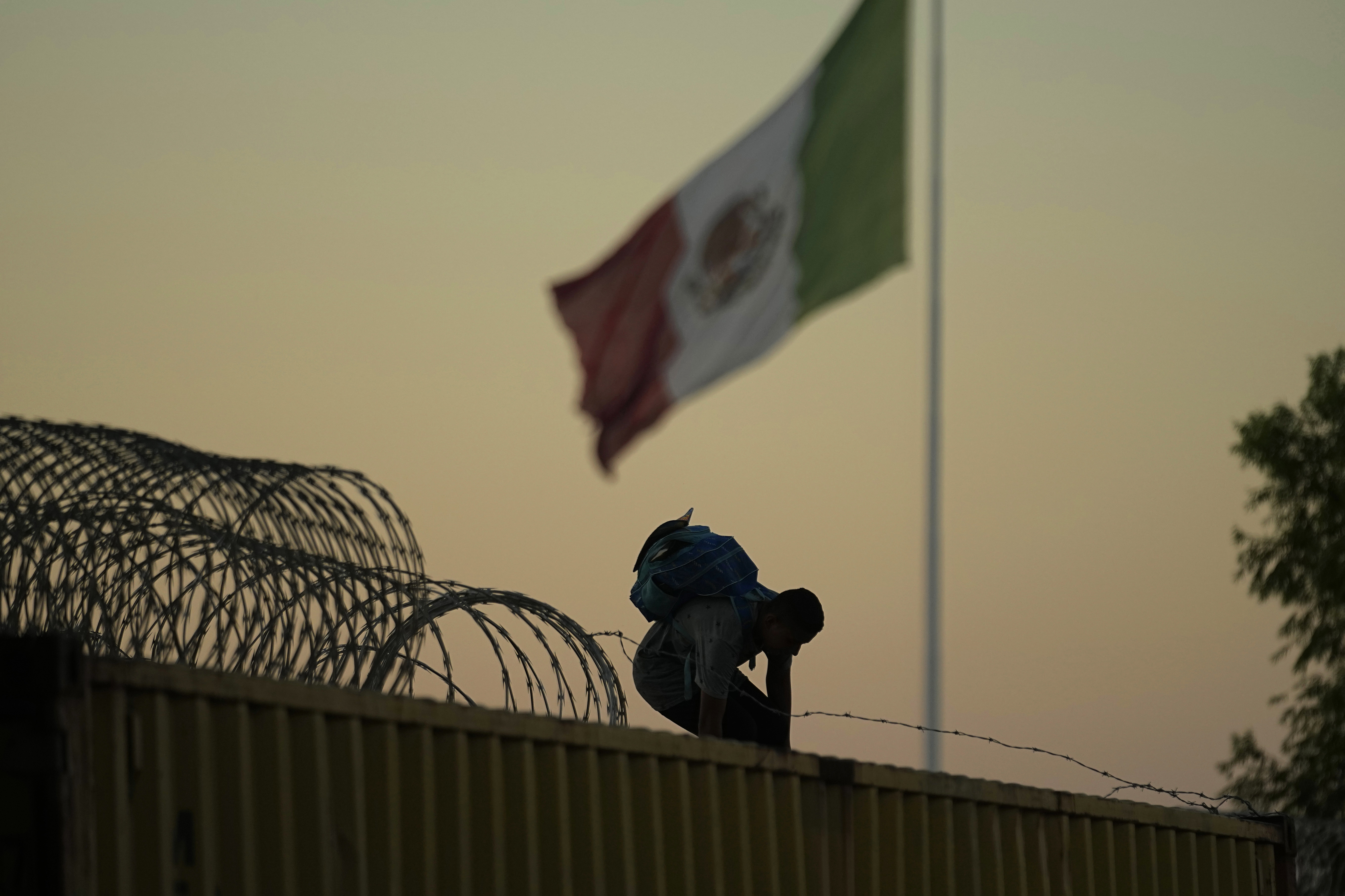 U.S. Customs agent David Gonzalez helps a traveler from Mexico use