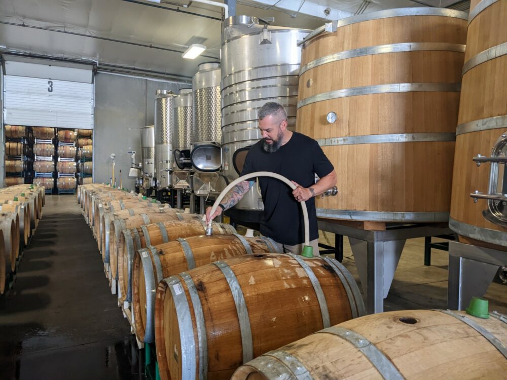 Winemaker Mitch Venohr soaks some wooden wine barrels to prepare them for wine. Barrels are hydrated to tighten the wood and prevent leaking.