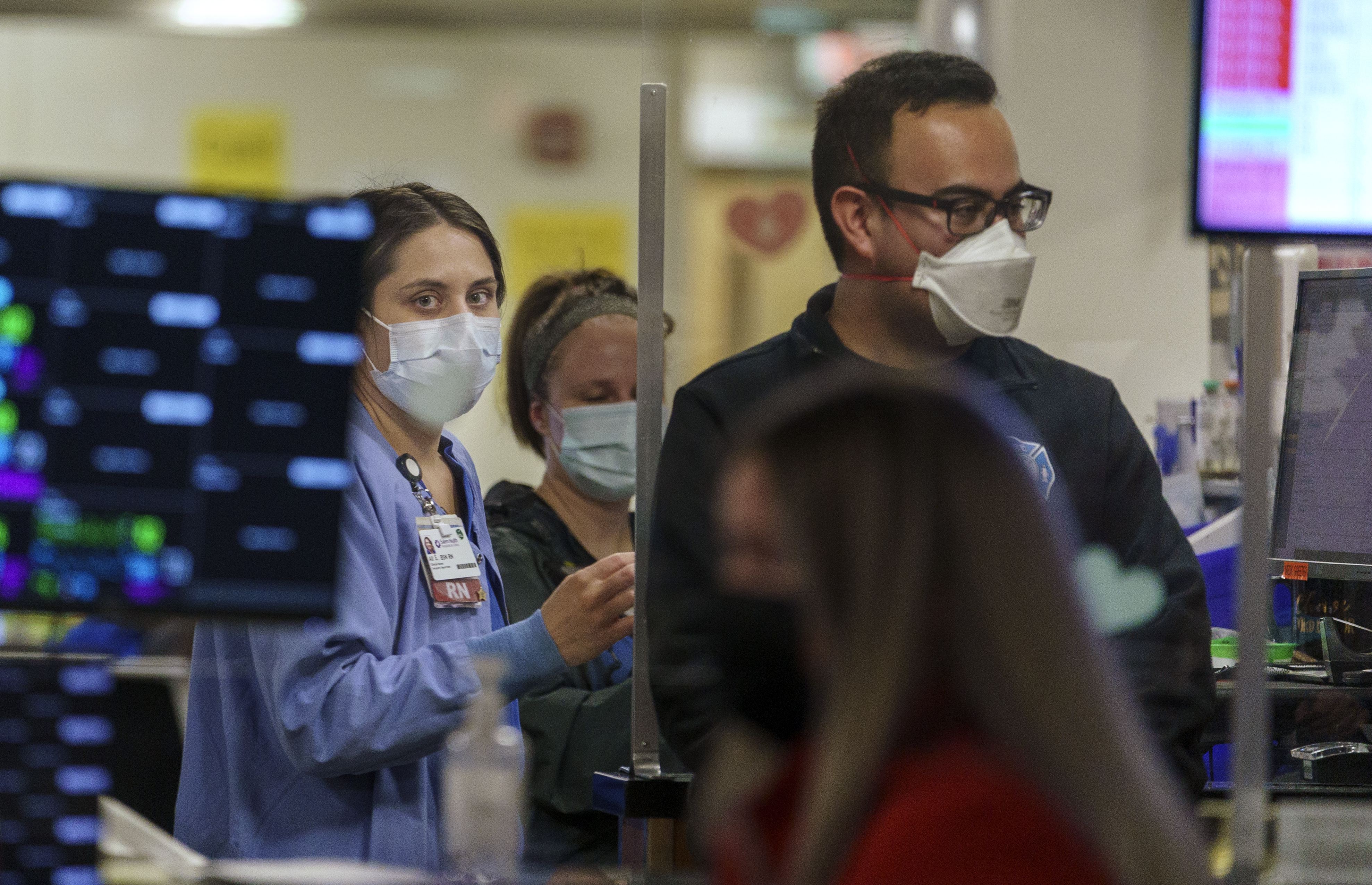 FILE: Nurse Ali Strawn, left, evaluates patients coming via ambulance to the Salem Health Emergency department in Salem, Ore., Jan. 27, 2022.