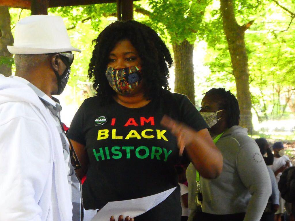 Co-founder of the Black Resilience Fund, Salomé Chimuku, speaking with an attendee of a July event where volunteers conducted in-person intakes and distributed funds to Black Portlanders in need.