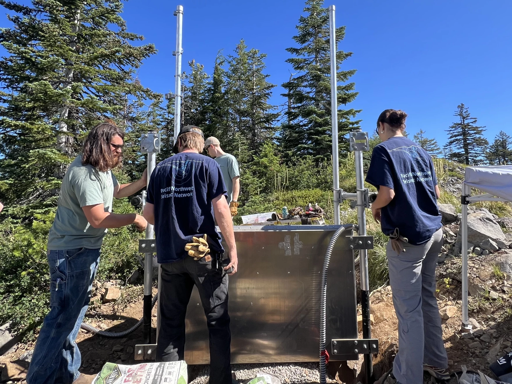 (L-R) Dylan Whitney, Ben Aldridge, Hayden Peabody and Karlee Giuntoli inspect the power source panel for the seismic sensors.