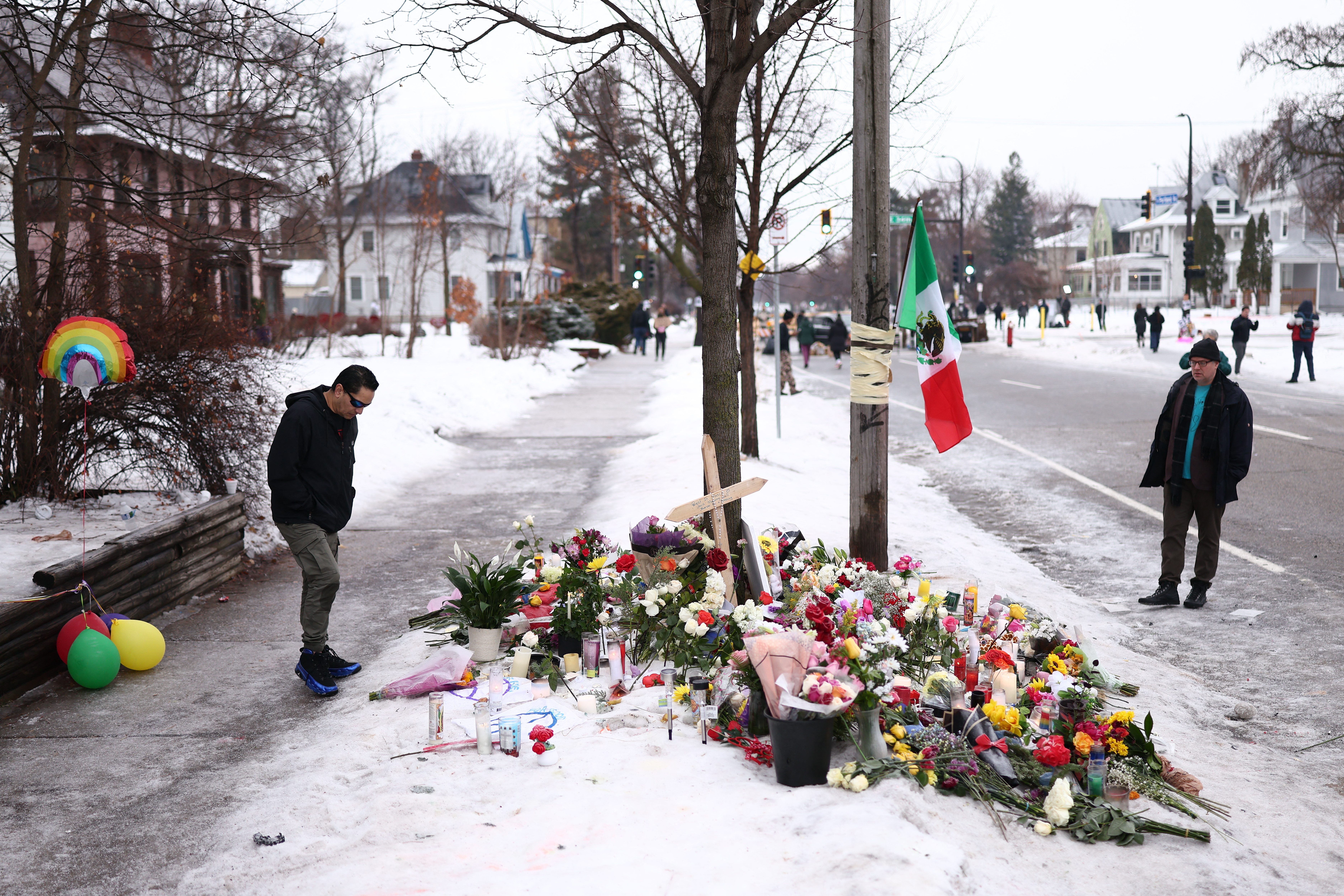 People gather at a makeshift memorial for Renee Nicole Good, 37, who was shot and killed on Wednesday by an ICE officer as she apparently tried to drive away from a group of ICE officers in Minneapolis.