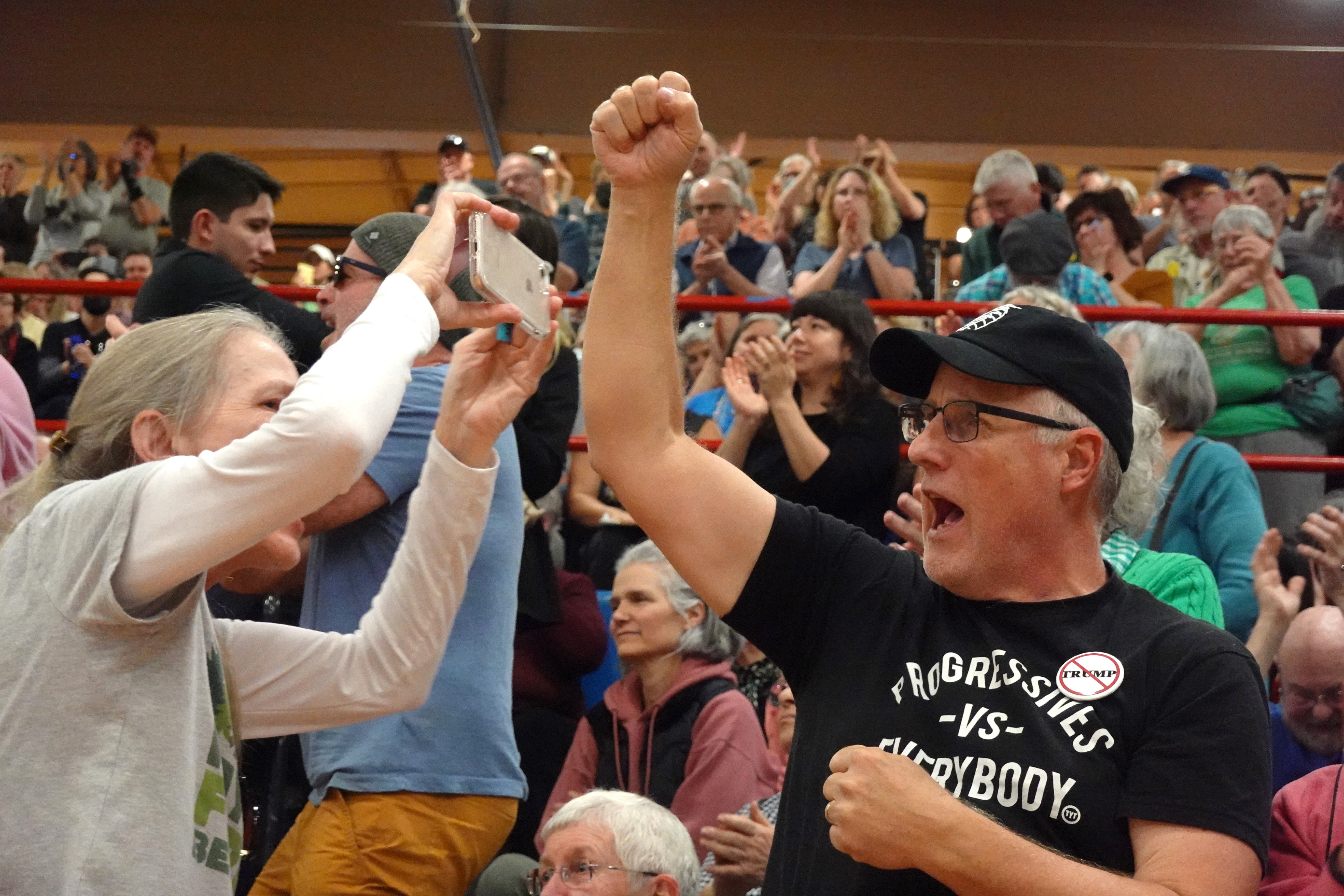 People chant "fight back" at the town hall.
