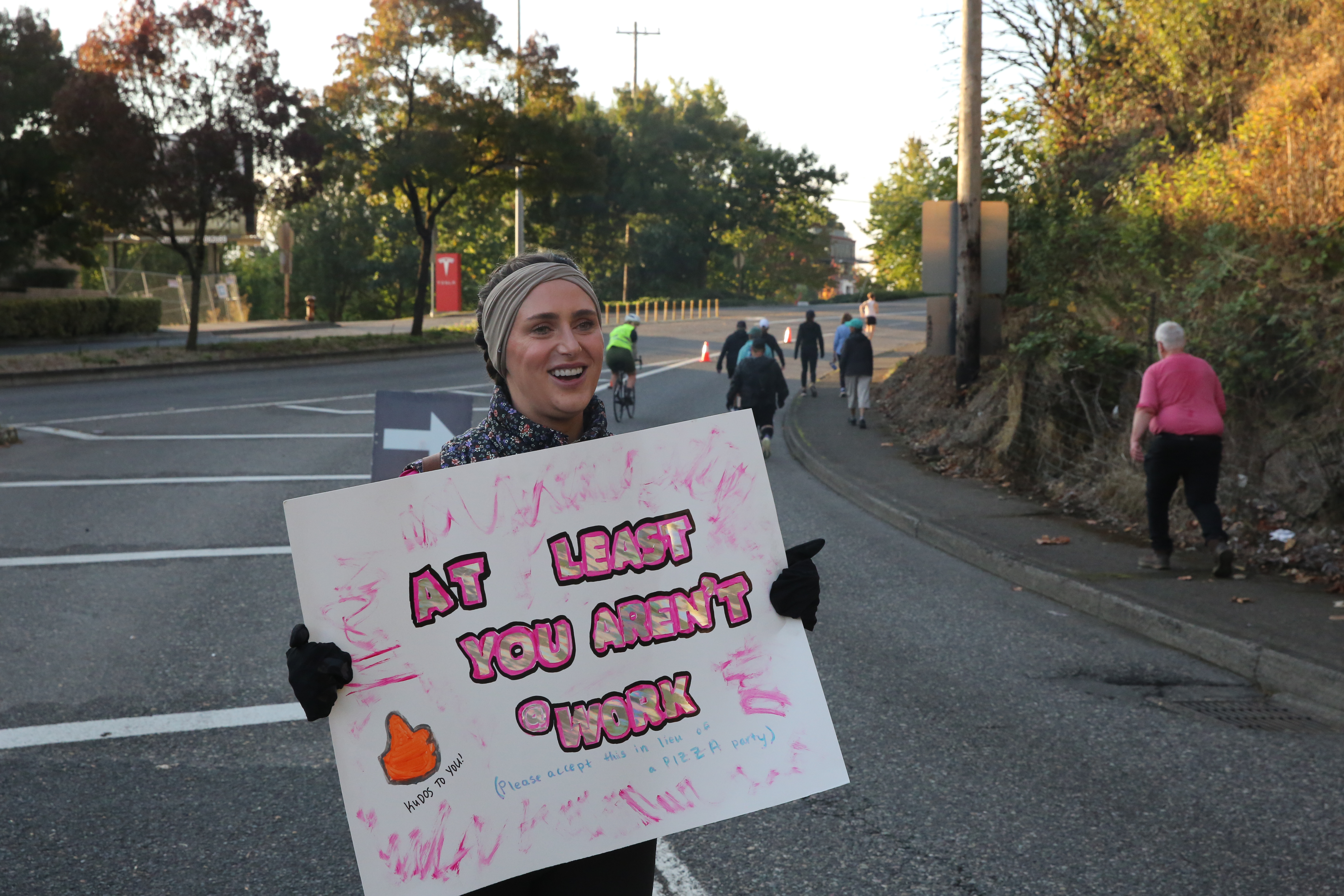 Anna Carlton cheers marathoners outside ICE. She chose the spot to show people the area isn't dangerous despite the protests. Oct. 5 2025