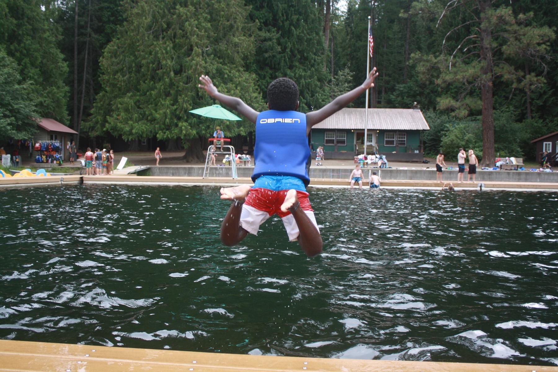 Happiest kid at camp jumps into the lake