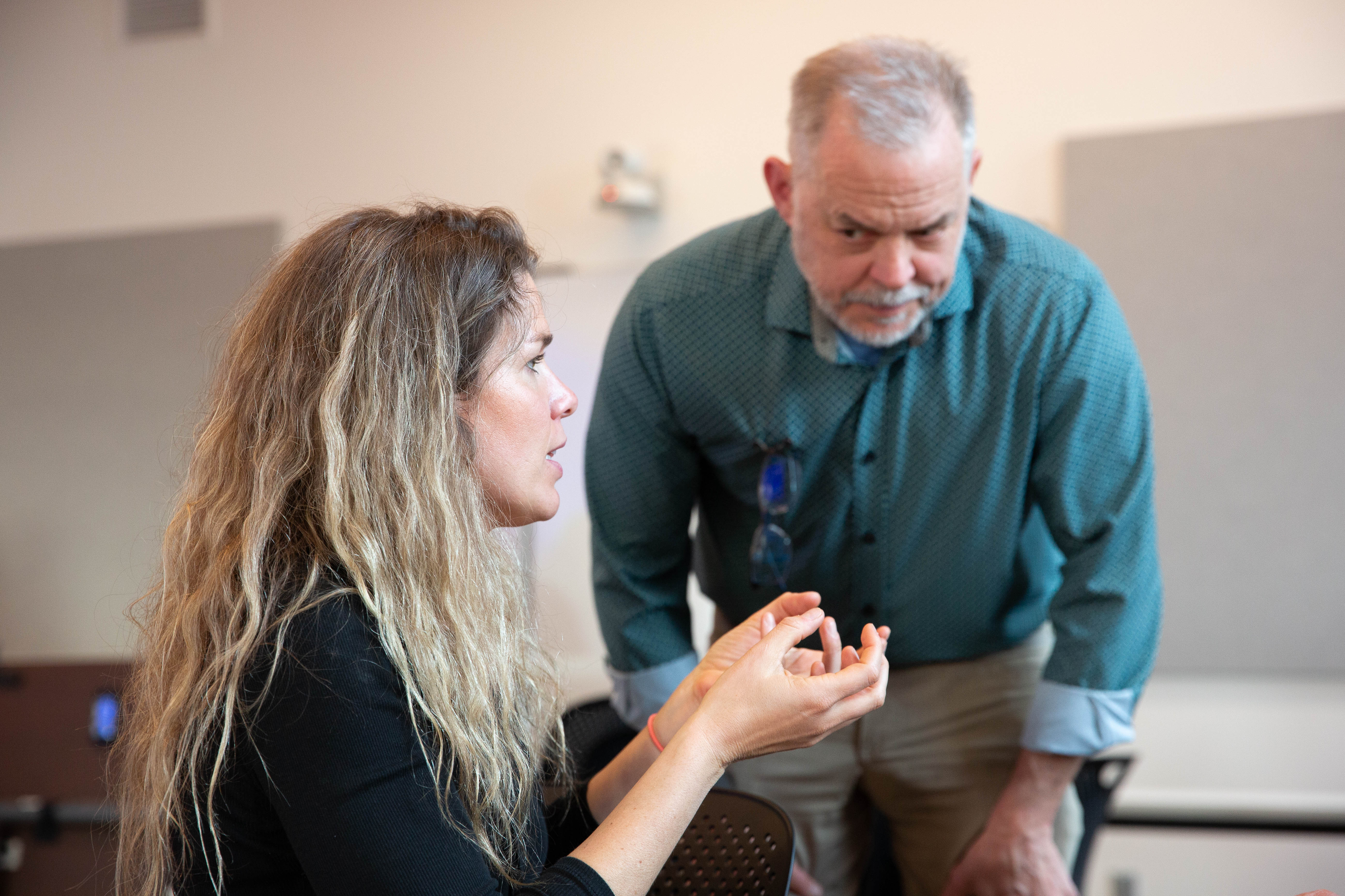(left) Cassie Lacy, senior management analyst for the City of Bend, discusses the electrification policy while City Councilor Steve Platt looks on in Bend, Ore., on April 8, 2026.