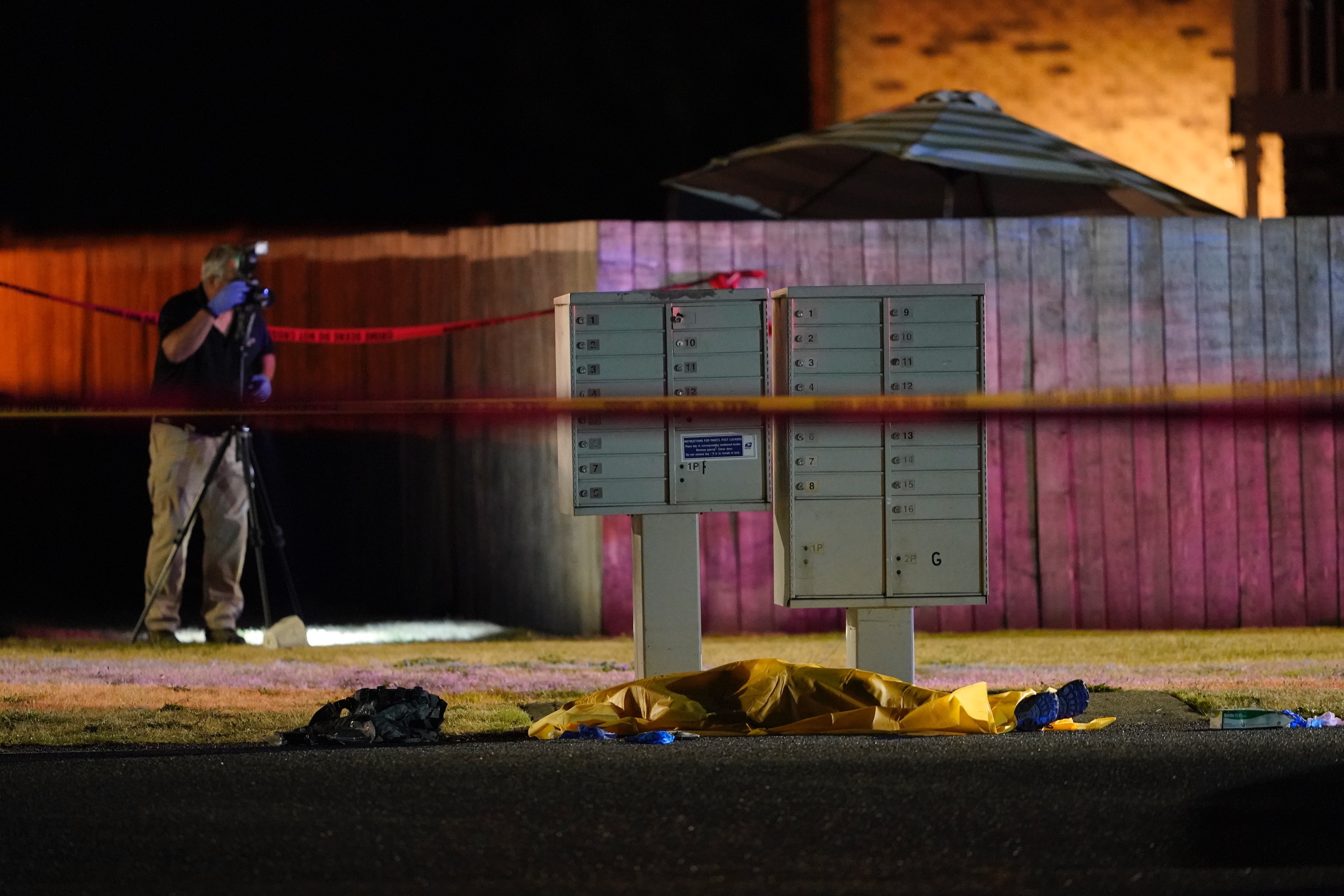 Officials work at a scene late Thursday, Sept. 3, 2020, where a man suspected of fatally shooting a supporter of a right-wing group in Portland, Ore., the week before was killed as investigators moved in to arrest him in Lacey, Wash. Michael Reinoehl, 48, was killed as a federal task force attempted to apprehend him in Lacey, a senior Justice Department official said. Reinoehl was the prime suspect in the killing of 39-year-old Aaron “Jay” Danielson, who was shot in the chest Saturday night, the official said.