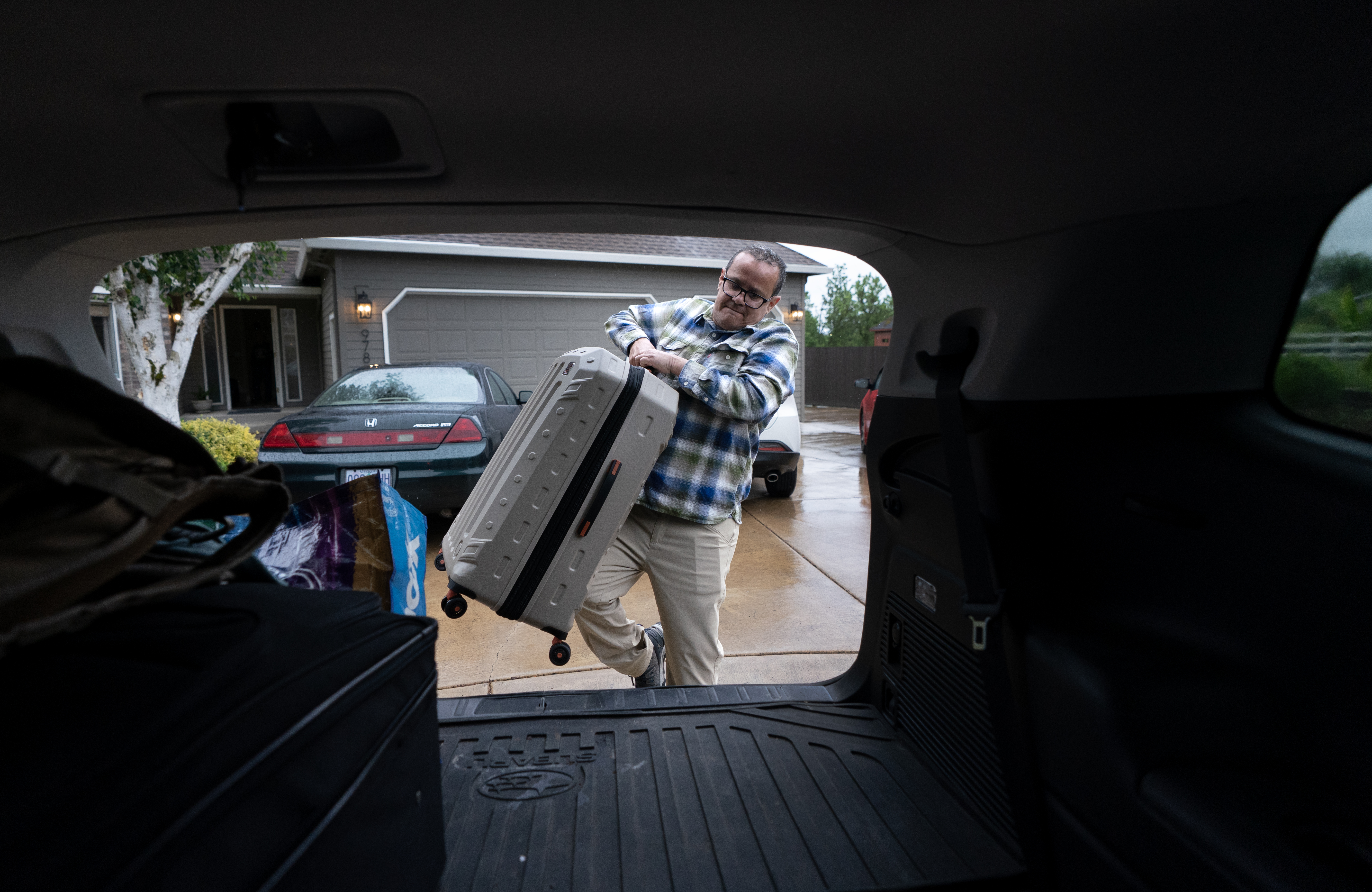 Luis Lamas loads his belongings into a car, as he prepares to leave his home in Woodburn, Ore., May 17, 2025. Lamas   arrived in the United States in 2021 looking for economic opportunity and overstayed his temporary tourist visa. Lamas chose to leave the U.S. on his own accord, saying, “I don’t want to find out if they’re going to put me in a detention center.”