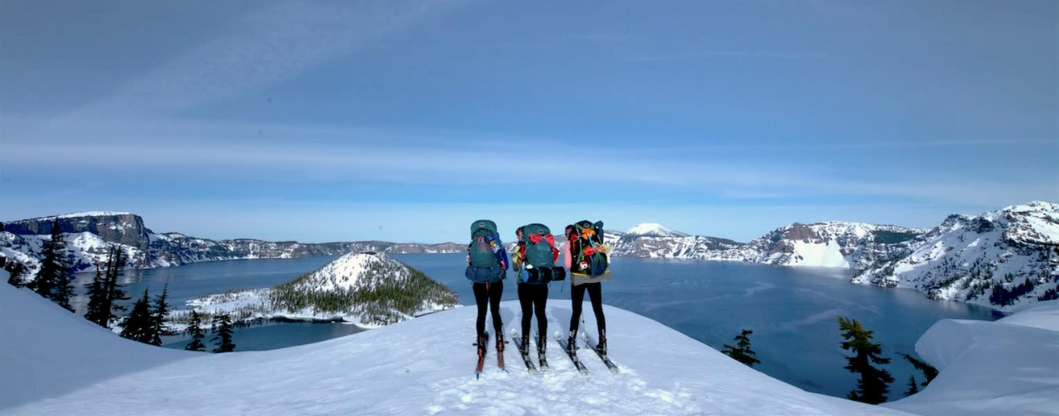 Three adventurous skiers about to circumnavigate Crater Lake.