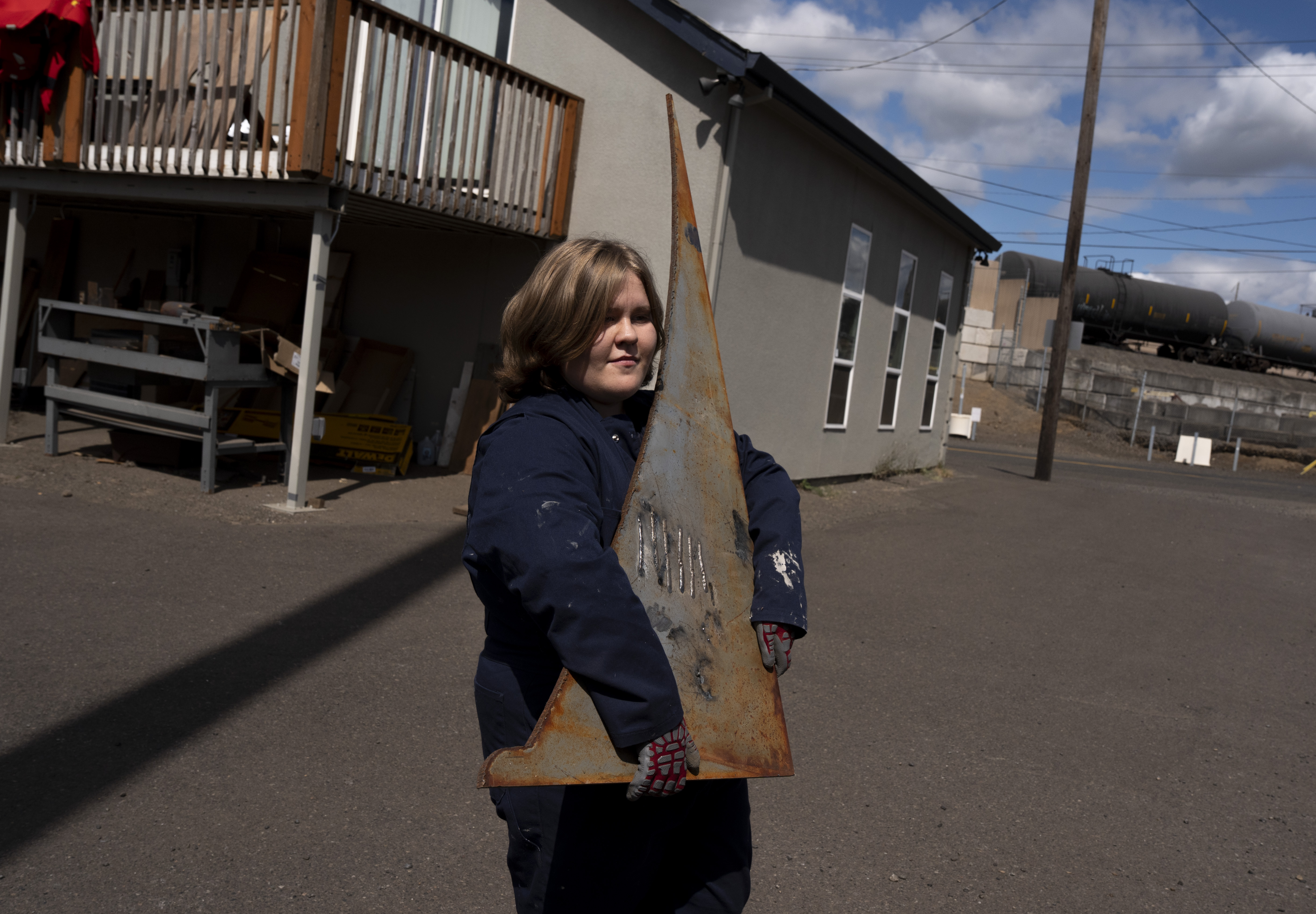 Second-year student Elli Gorman transports scrap metal to a storage area.