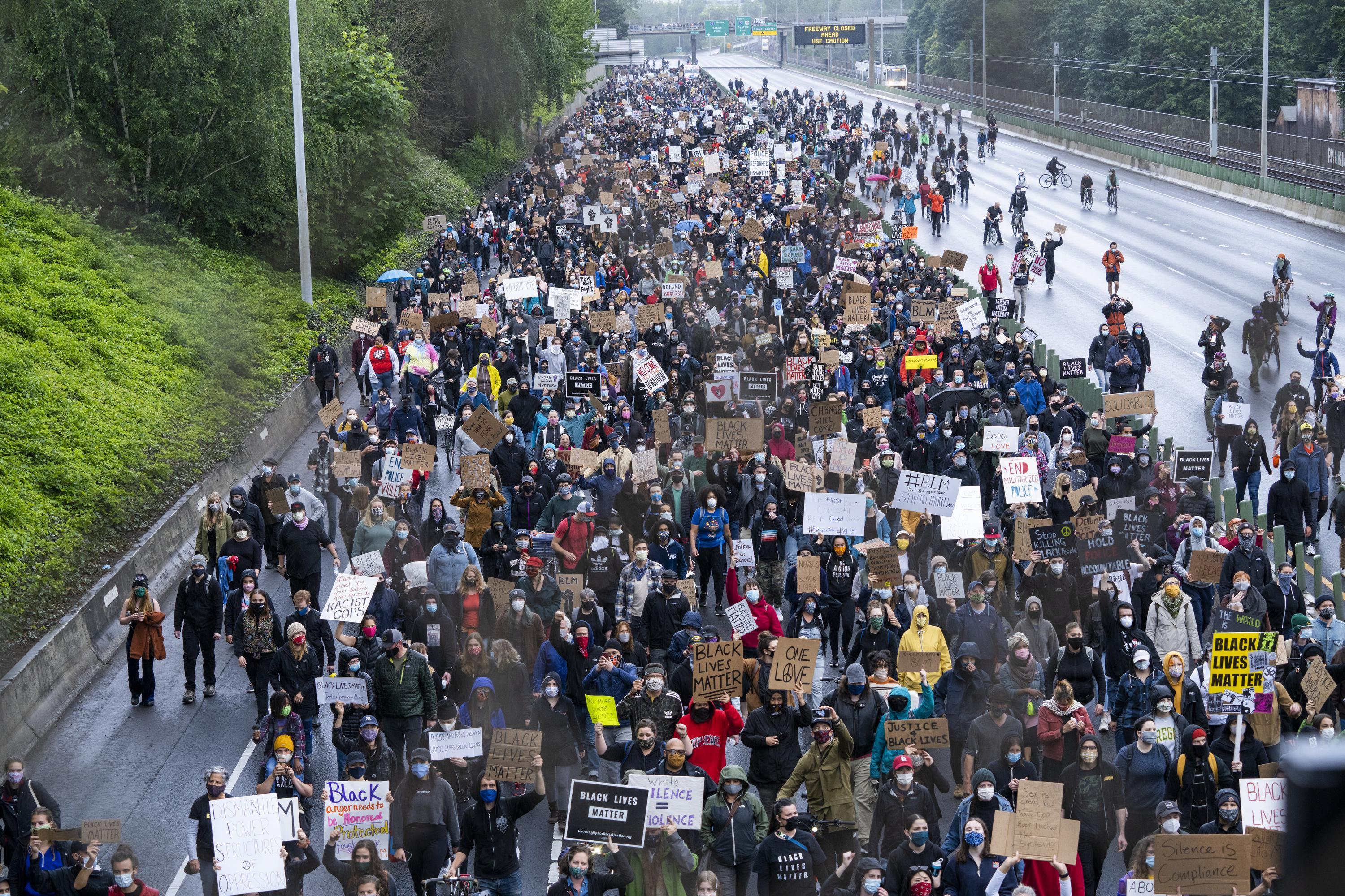 Protesters marching against racist violence and police brutality block traffic on Highway 84 in NE Portland on June 8, 2020. 