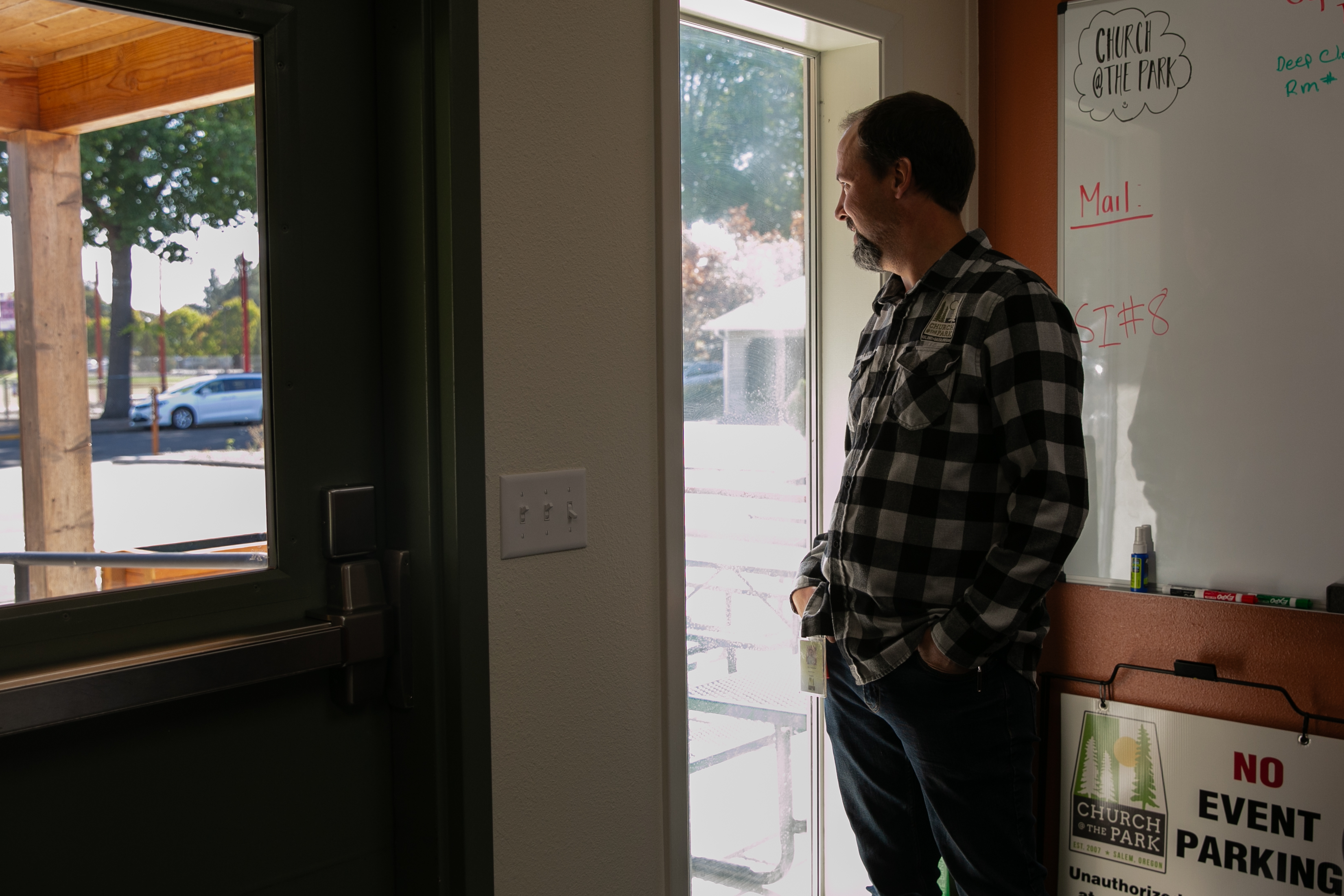 Chaplain Smucker glances out the lobby of the homeless shelter run by nonprofit Church at the Park. The new shelter has been open for three months.
