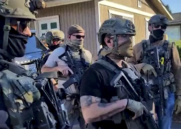 In a screenshot of a video provided to OPB, armed federal immigration officers are seen outside an apartment in Gresham, Ore., on Oct. 15, 2025. This screenshot was provided to OPB by a witness who asked not to be identified out of fear of repercussions.