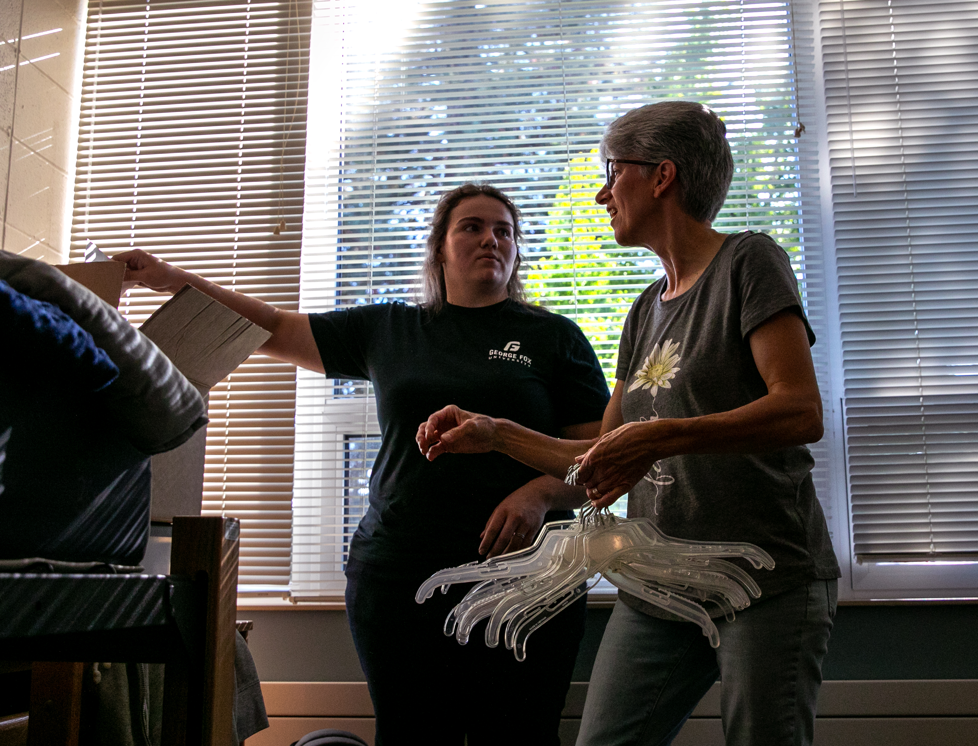 (Left to right) George Fox University freshman Esther Birt and her mother Myrene set up Birt's dorm room.